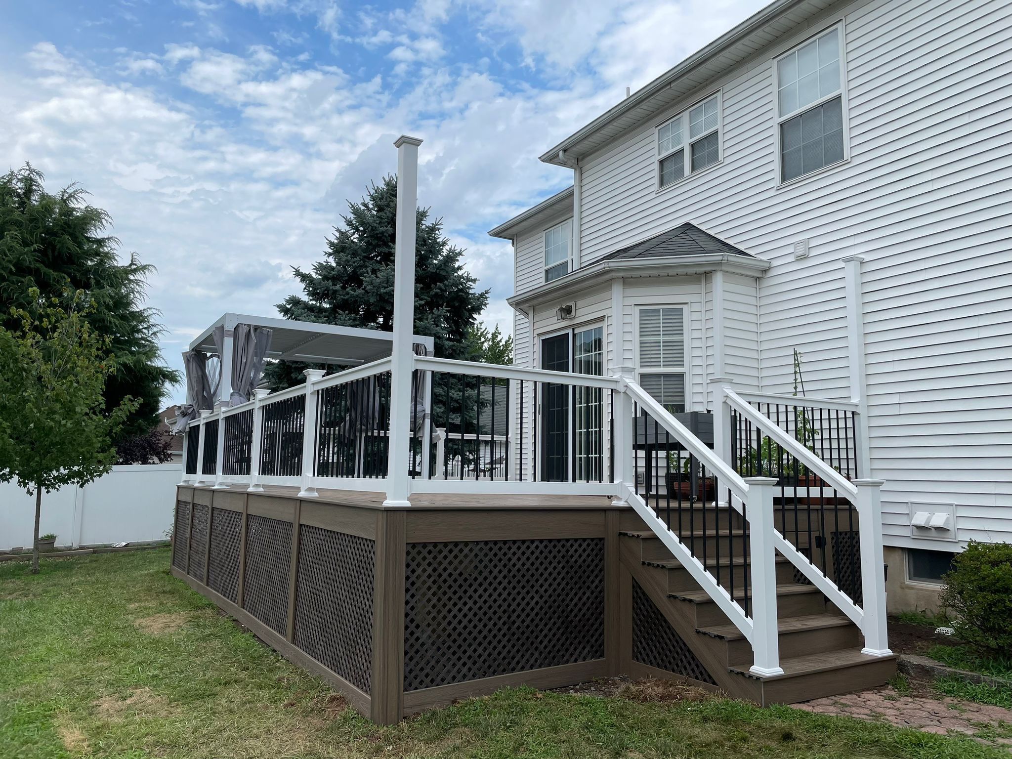 New Deck with Pergola and Vinyl Lattice by deck guardian