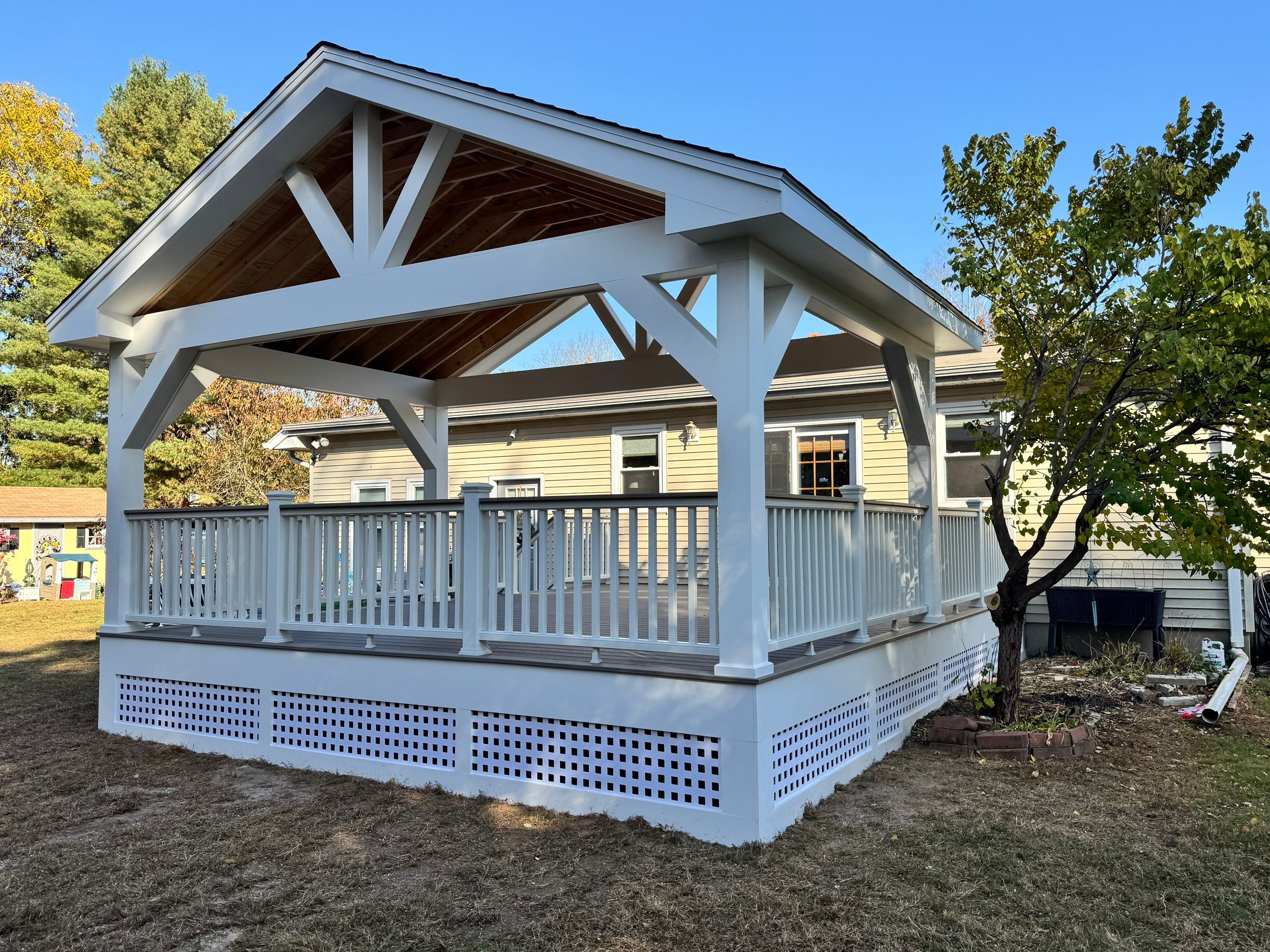 Replacement deck and Roof overhang. Trex Lineage Biscayne boards and matching cocktail rail.  by DiGiorgi Roofing and Siding Inc