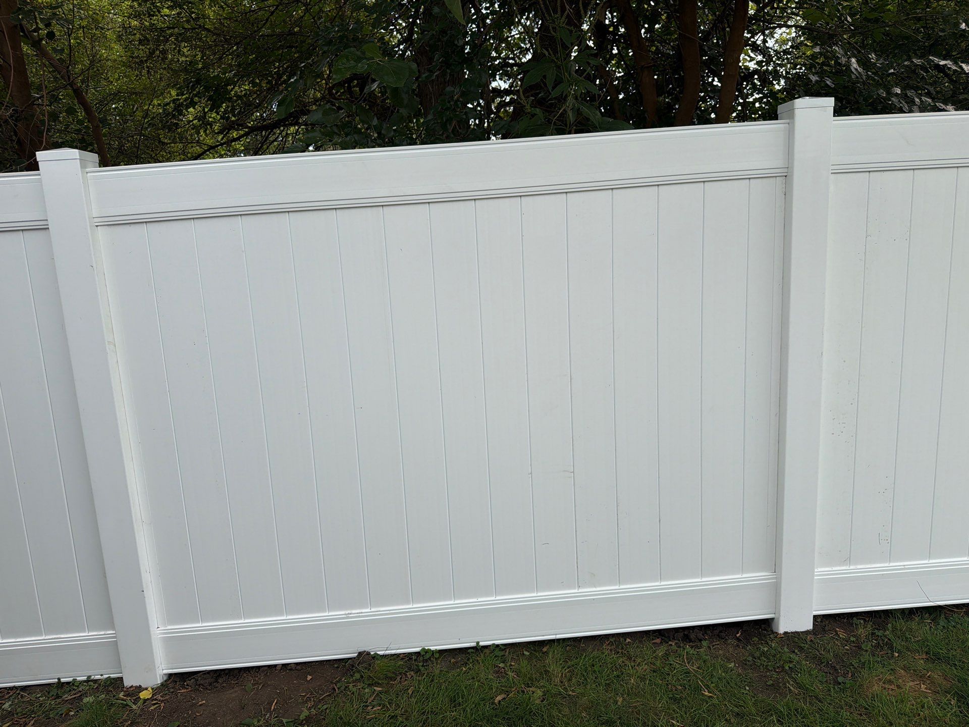 White Vinyl Privacy Fence Installation in Raymond, IA by Perfect Picket Fence and Stain