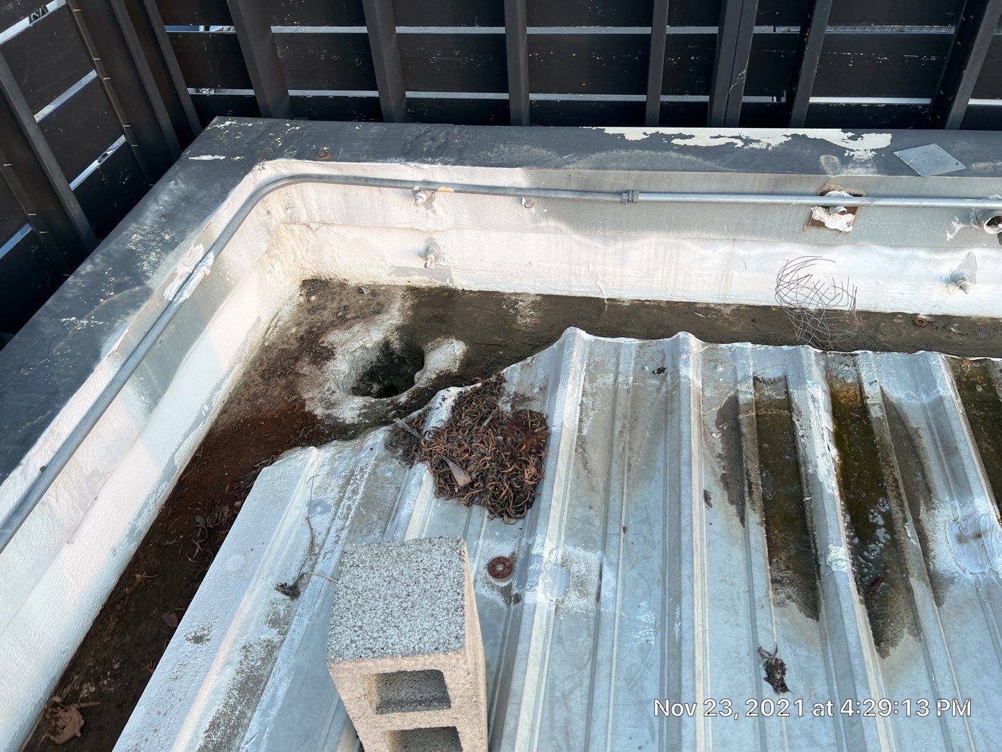 Metal roof restoration on commercial roof using Conklin Benchmark/ PUMA XL acrylic coatings over metal and foam by Straight Edge Roofing Inc