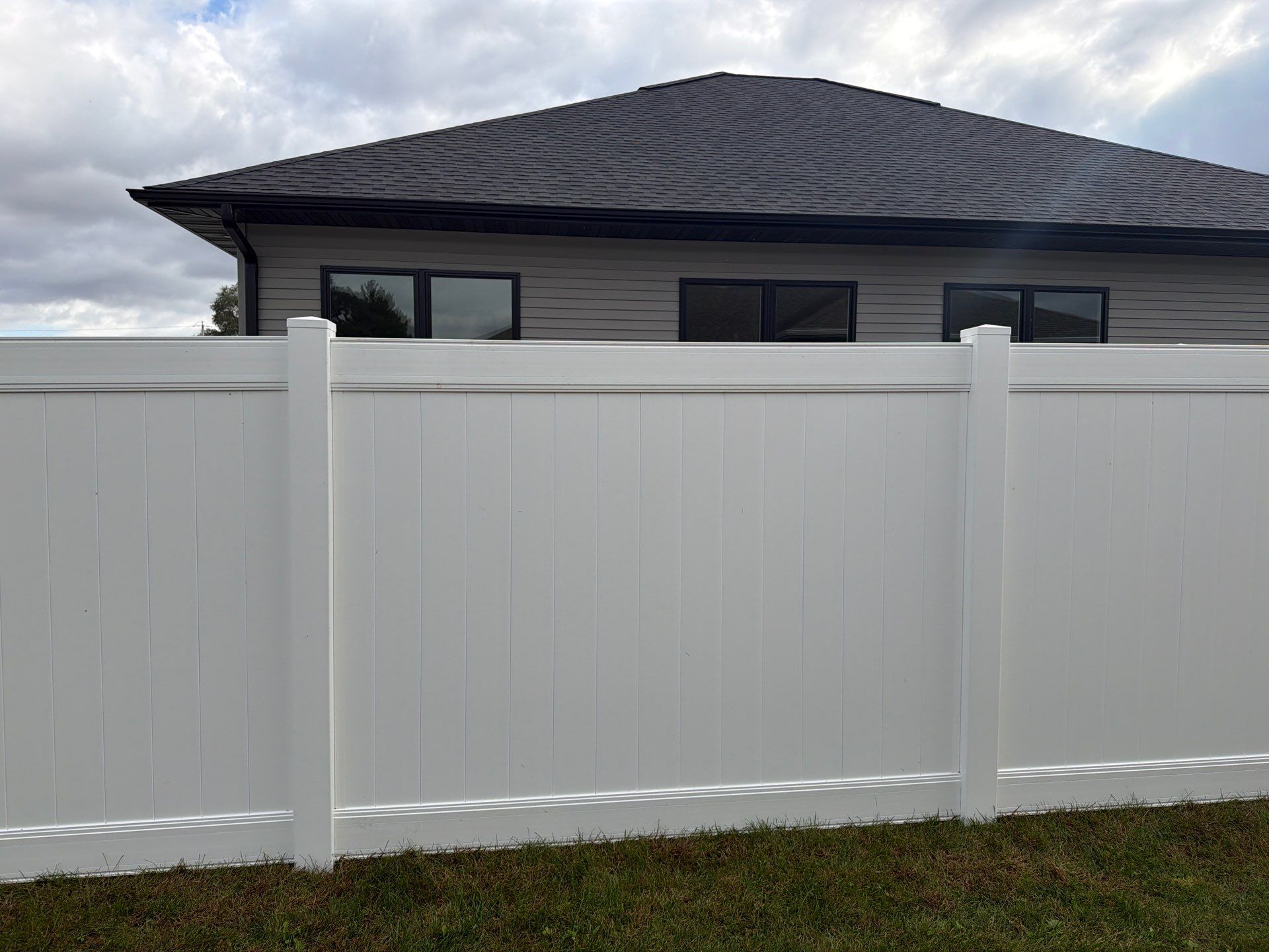 Residential White Vinyl Privacy Fence Installation in Janesville by Perfect Picket Fence and Stain