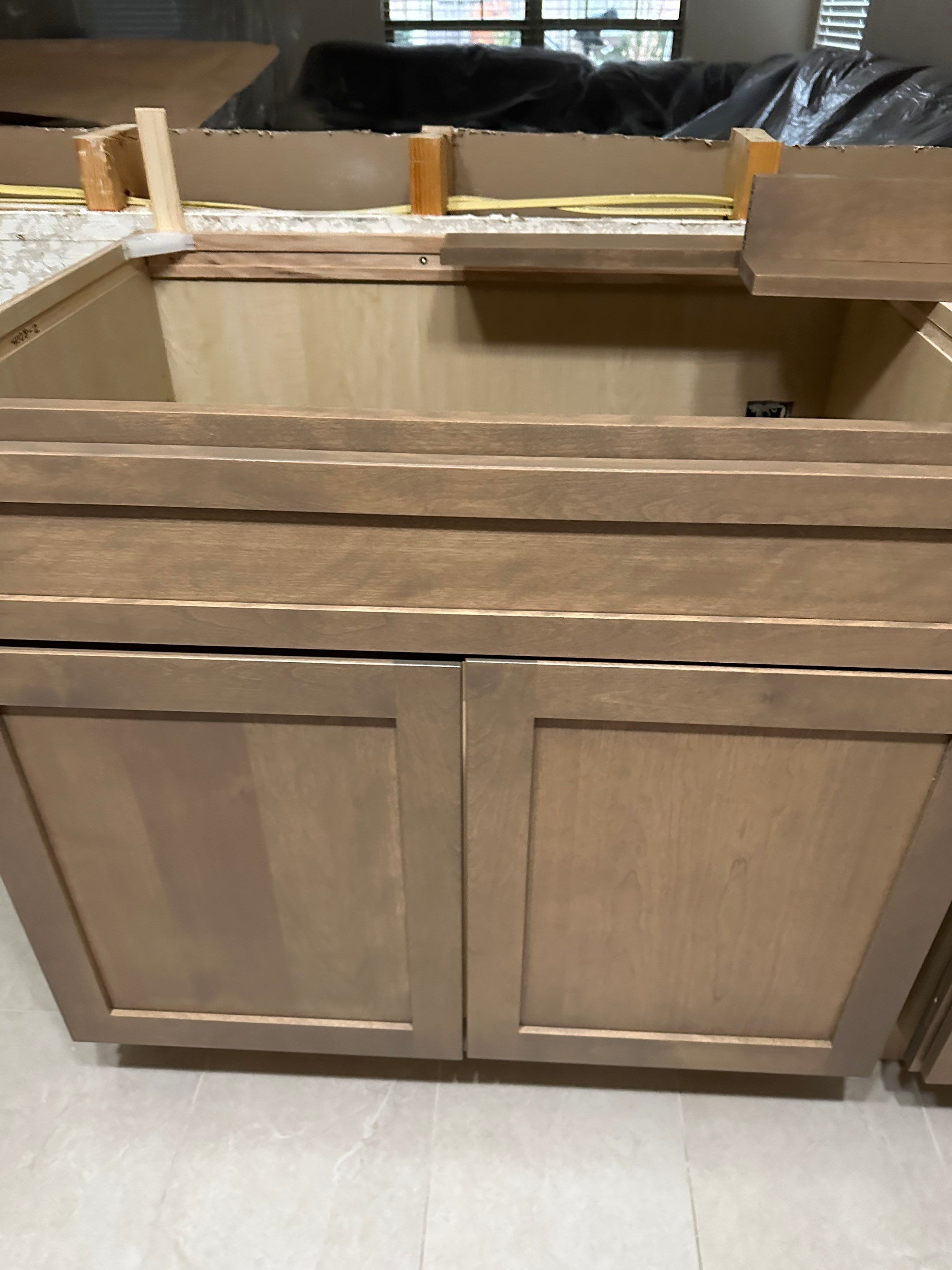 The old kitchen had a traditional builder-grade look with heavier wood cabinetry and busier finishes, while the new kitchen has a warm transitional design with cleaner lines, a brighter palette, and a more open, modern layout by Mena stone surfaces