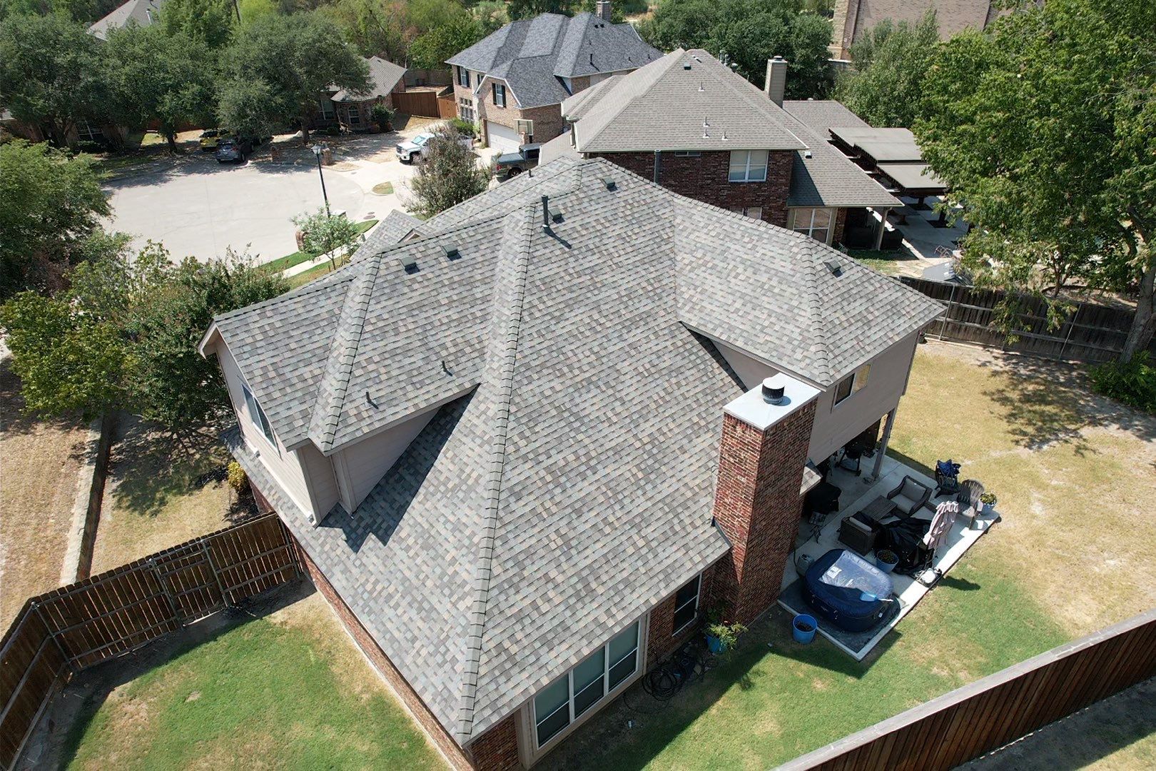 Red brick/white stone with IKO Cornerstone by Tejas Roofworks + Restoration