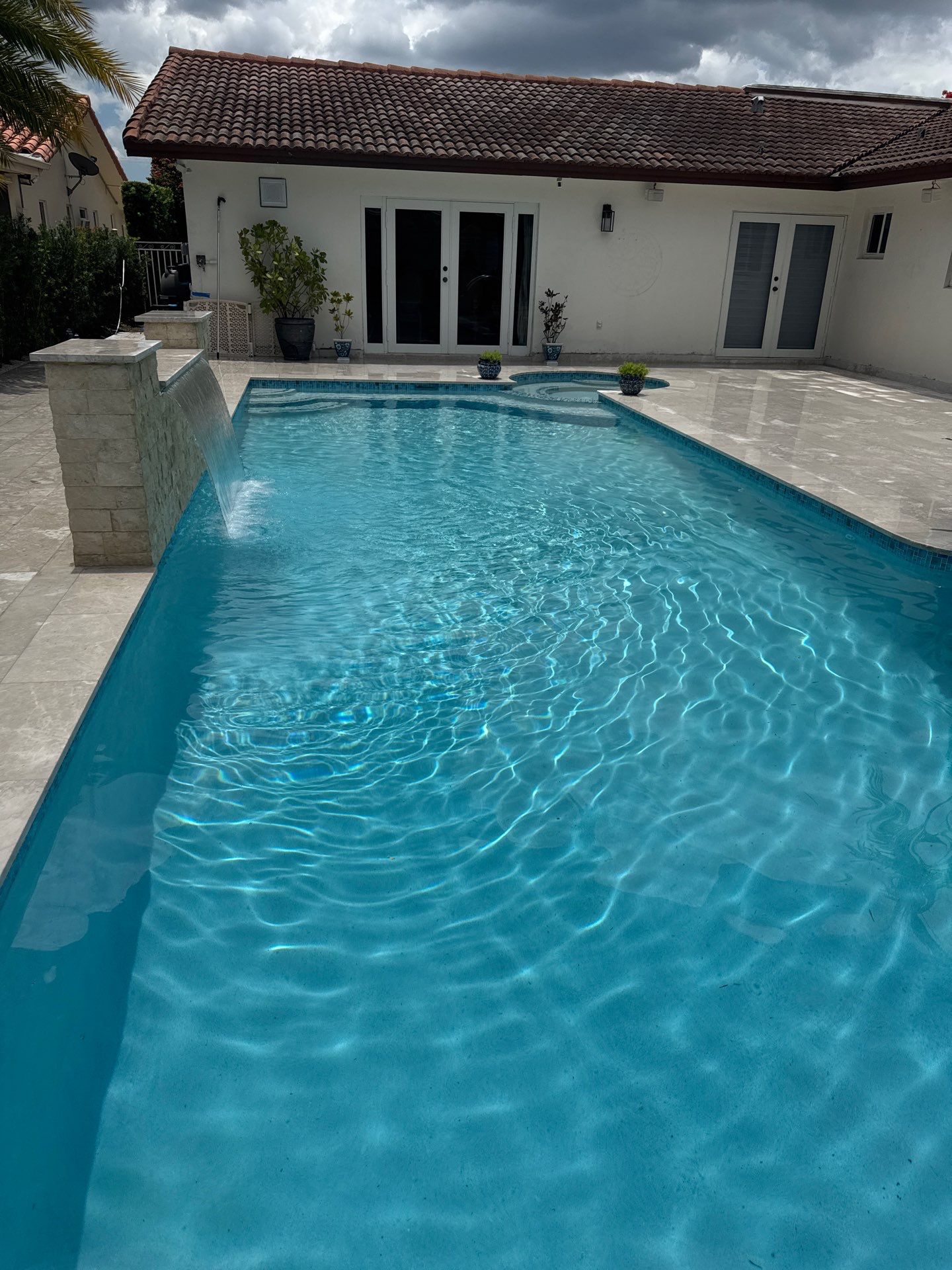 Watefall and bench addition by Pristine Pools Miami