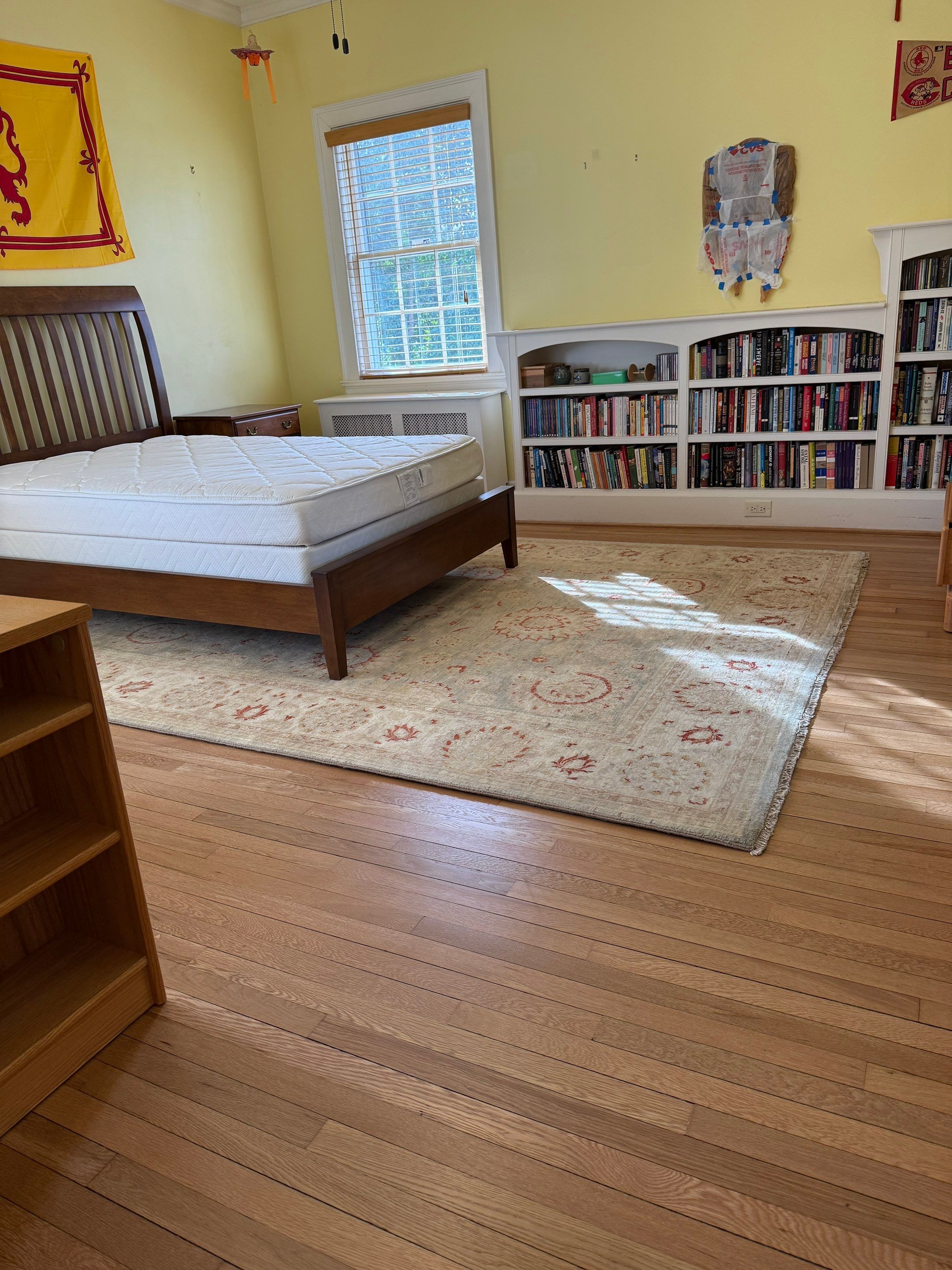 Two bedrooms with hardwood under carpet by Accent Custom Floors