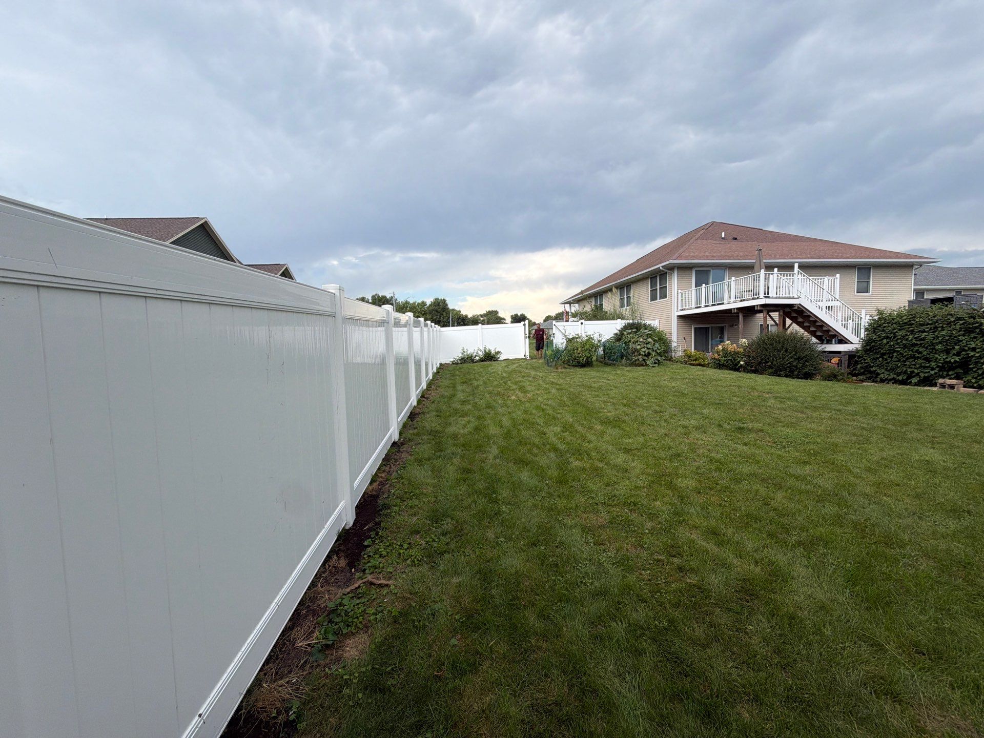 White Vinyl Privacy Fence Installation in Raymond, IA by Perfect Picket Fence and Stain