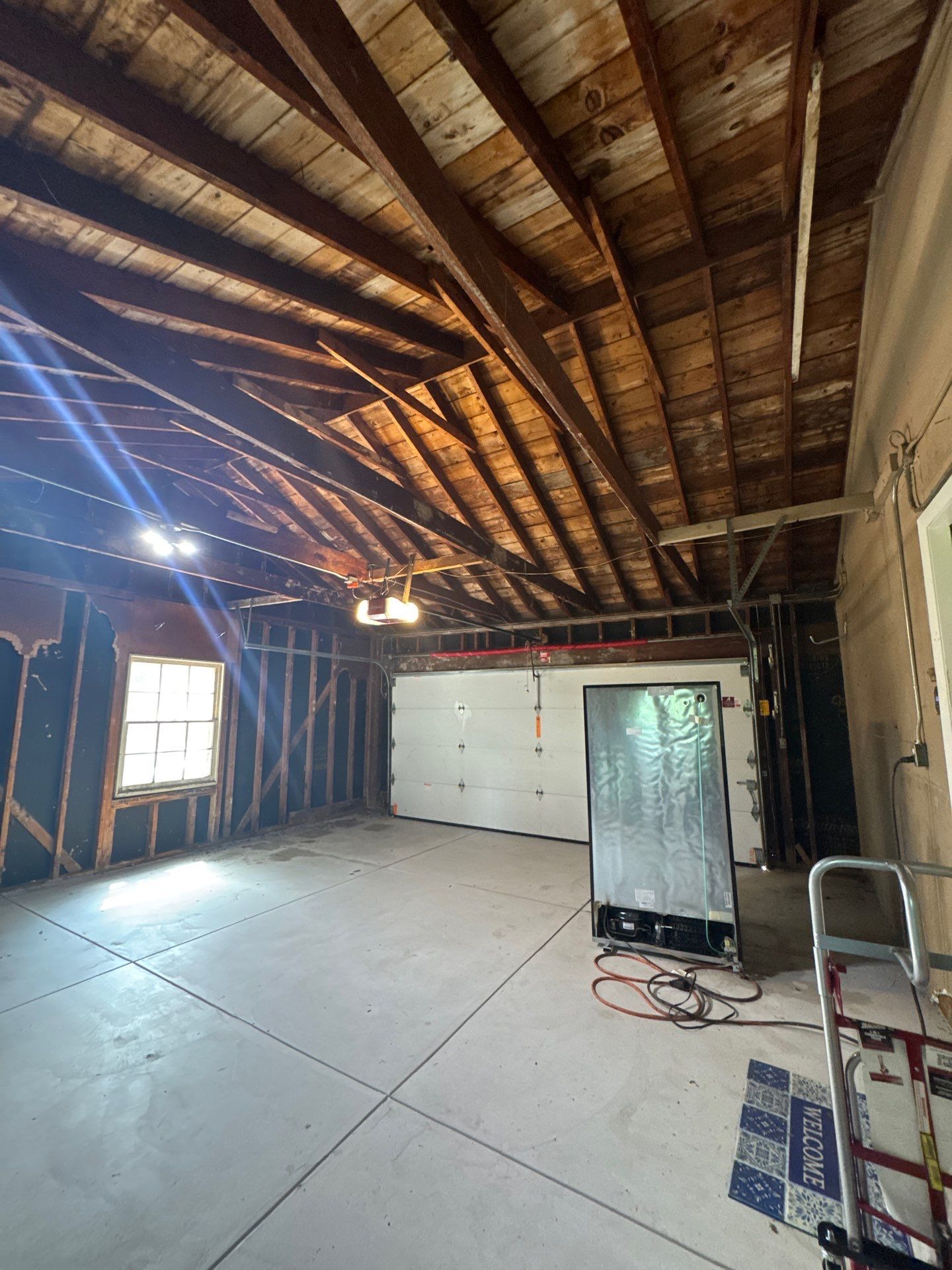 Bayside Garage Interior Remodel with Custom Epoxy Floor Coating by OCS Contracting Services