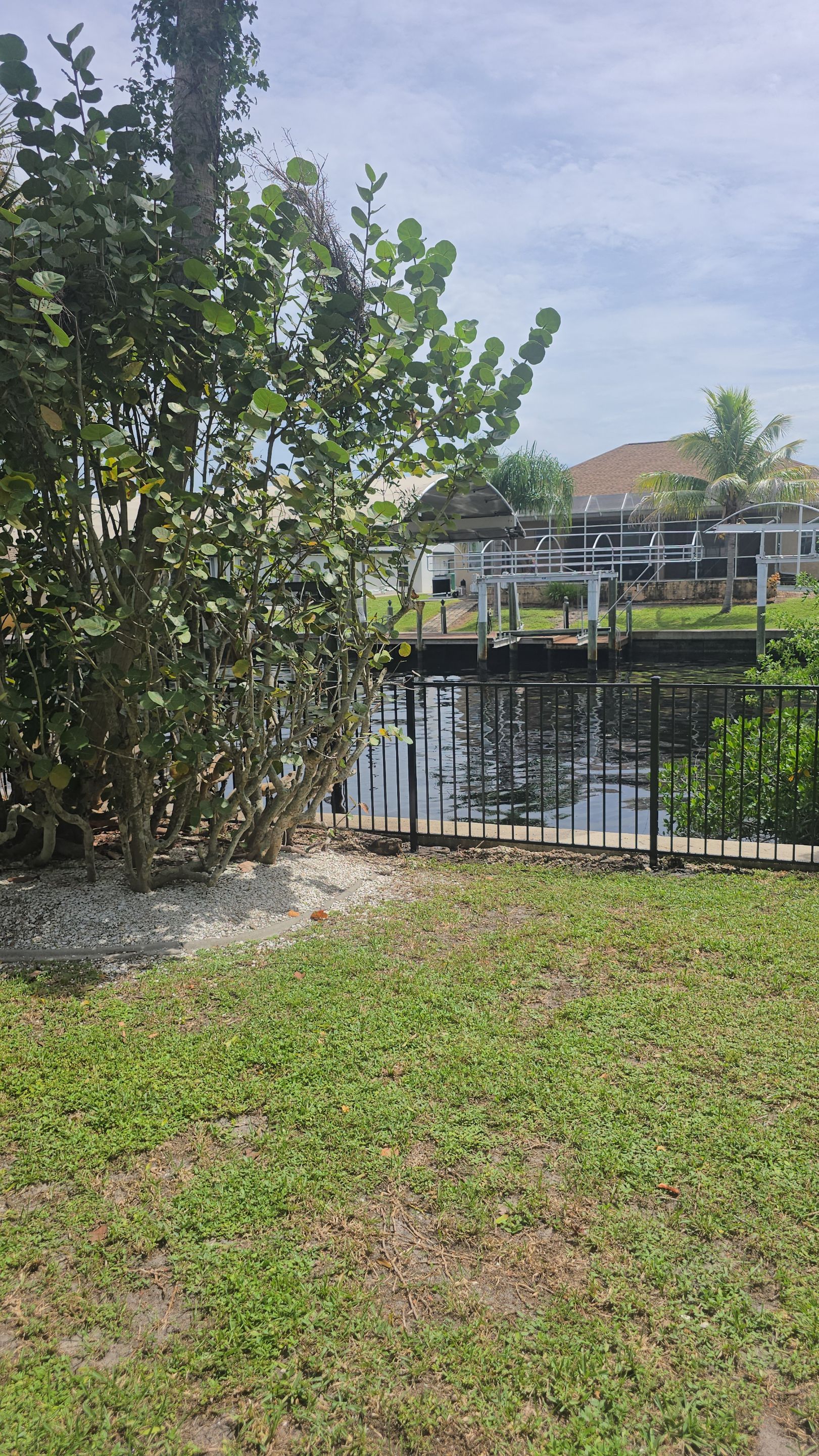Black Aluminum Picket Fence Installation for Port Charlotte Canal Home by True Fence LLC