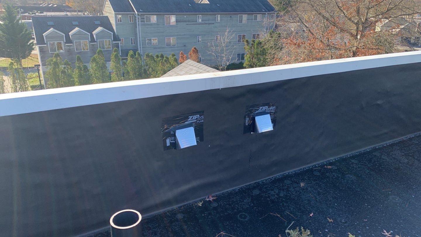 Commercial Roofing Installation using EPDM with white gutters by A Plus Exterior