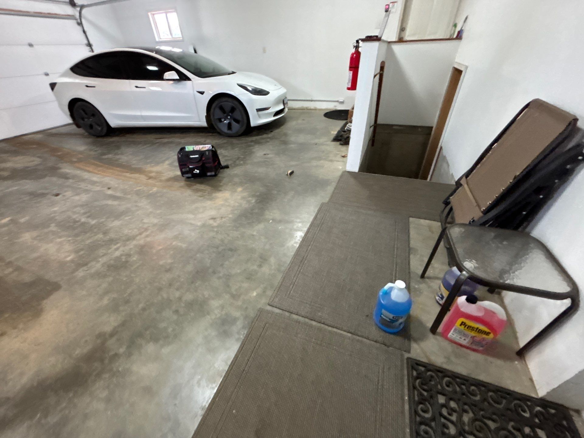 Full Garage Floor and Basement Stair Epoxy Coating in Sioux Falls by Select Painting, Coatings & Garage Cabinets