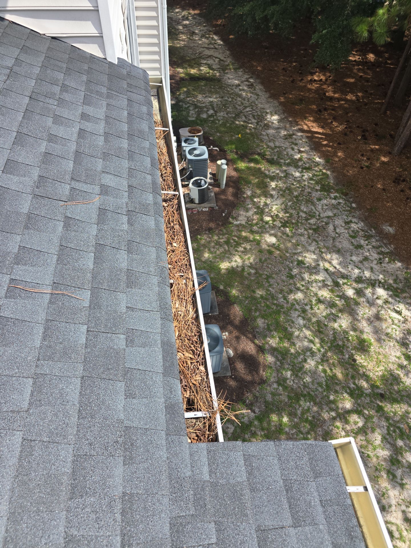 Commercial gutter cleaning Wilmington, NC before photo with filled gutters