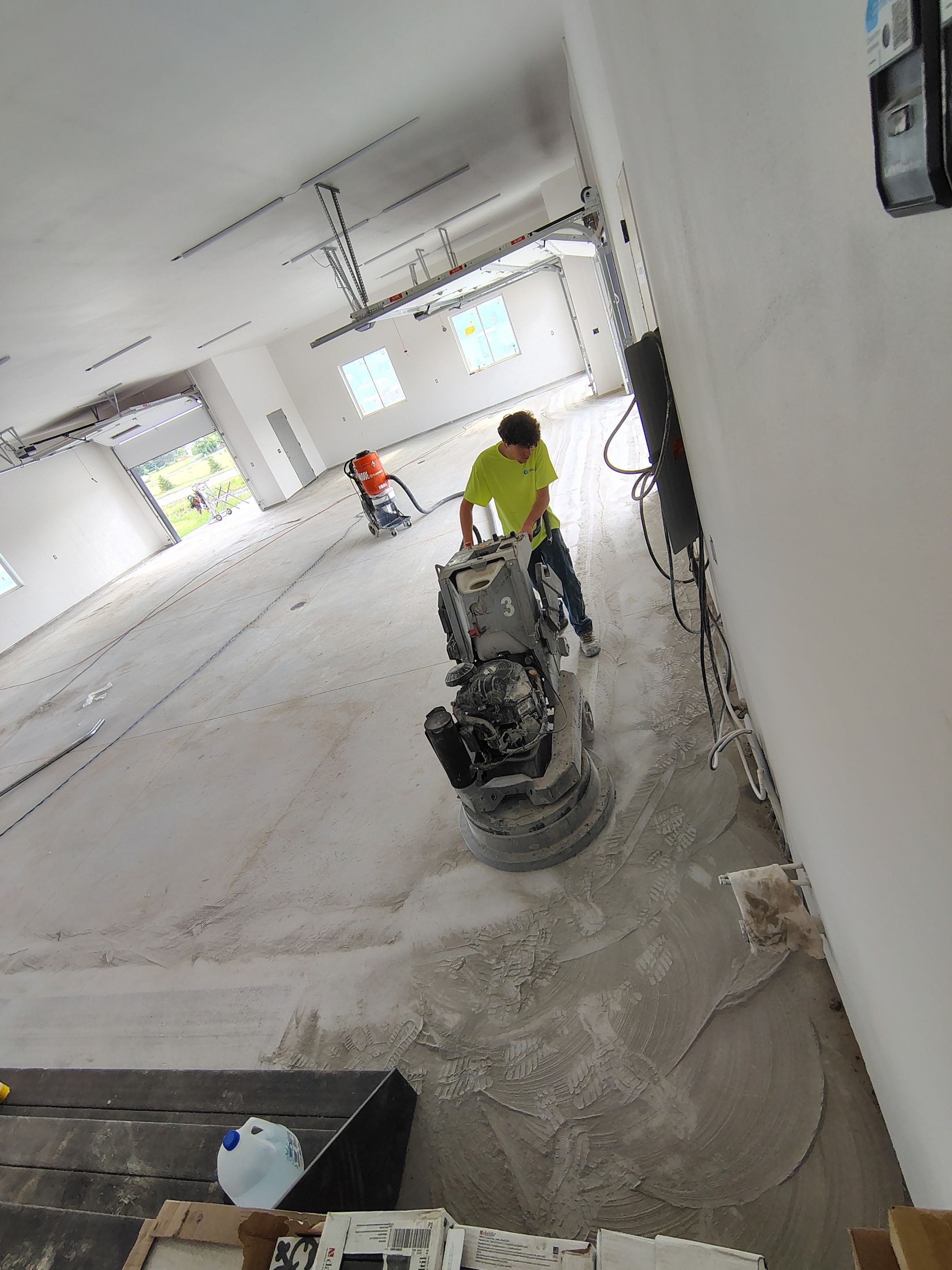 Multi-Bay Garage Concrete Coating and Floor Refinishing in South Dakota by Select Painting, Coatings & Garage Cabinets