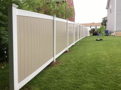 New two tone White and Clay Vinyl privacy fence.