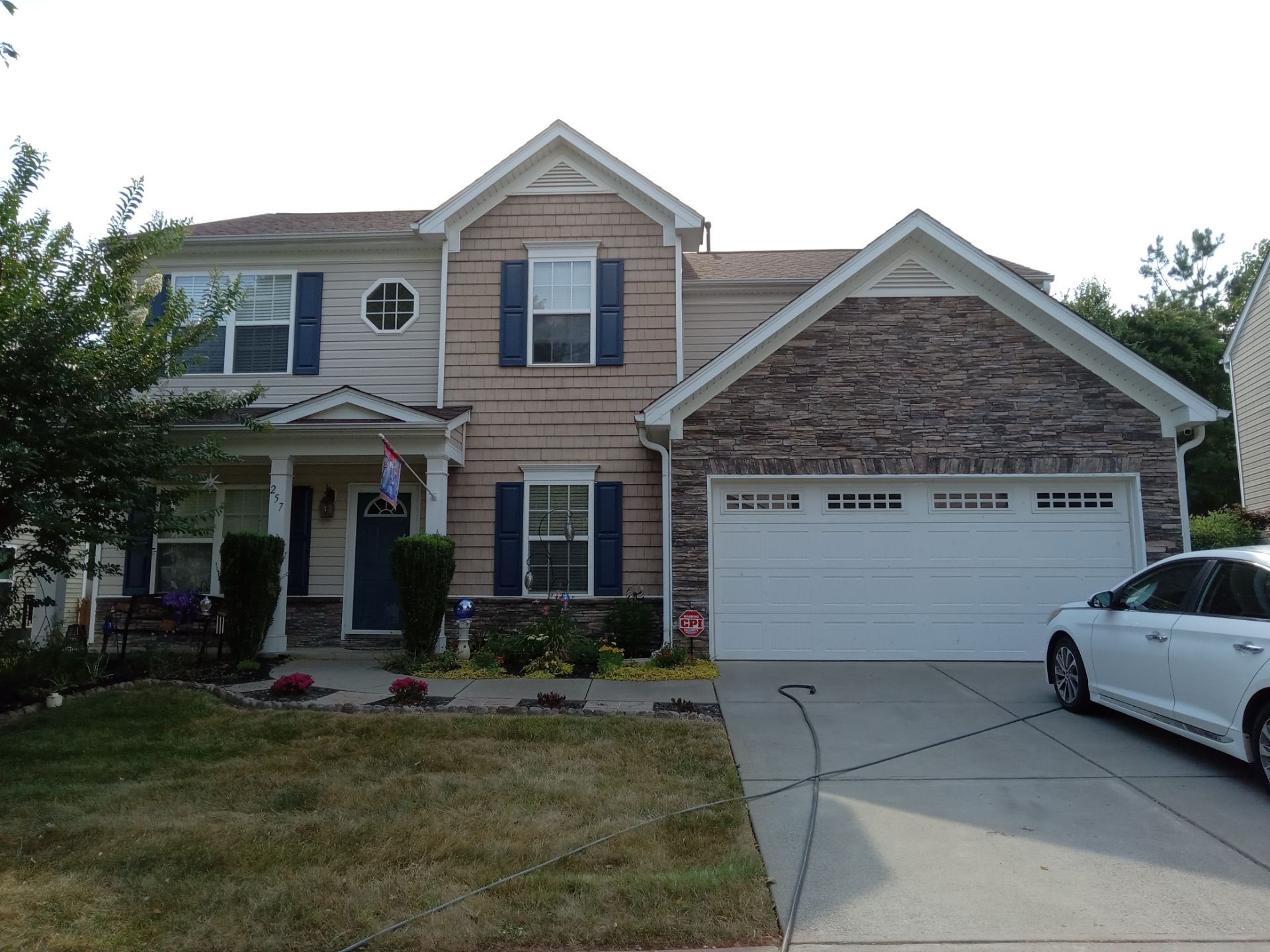 pressure washing company cleaning house exterior siding garage door and driveway in kernersville nc area