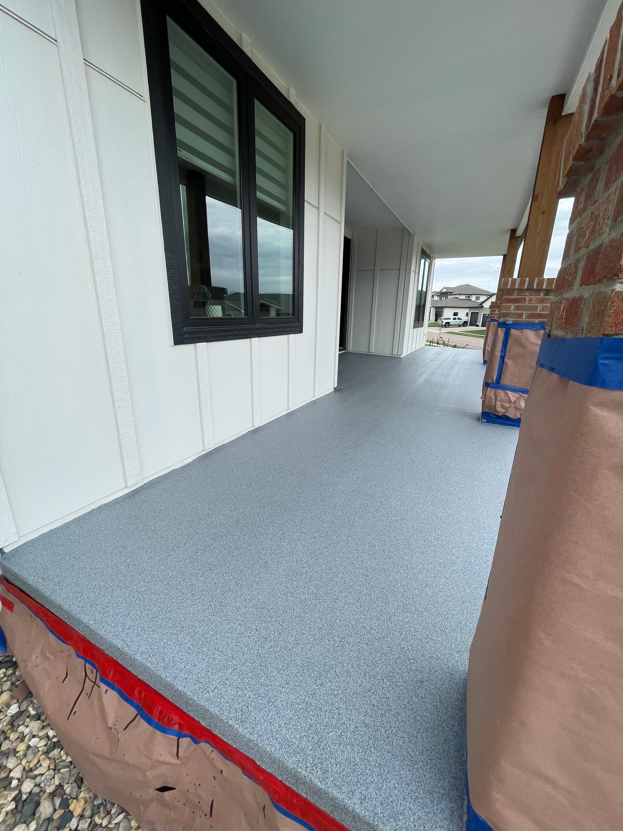 Grey Speckled Concrete Porch Coating for Sioux Falls Home by Select Painting, Coatings & Garage Cabinets
