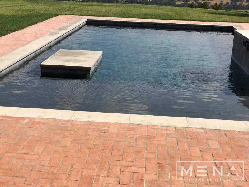 Kitchen, outdoor kitchen and pool brick floor installation by Mena stone surfaces
