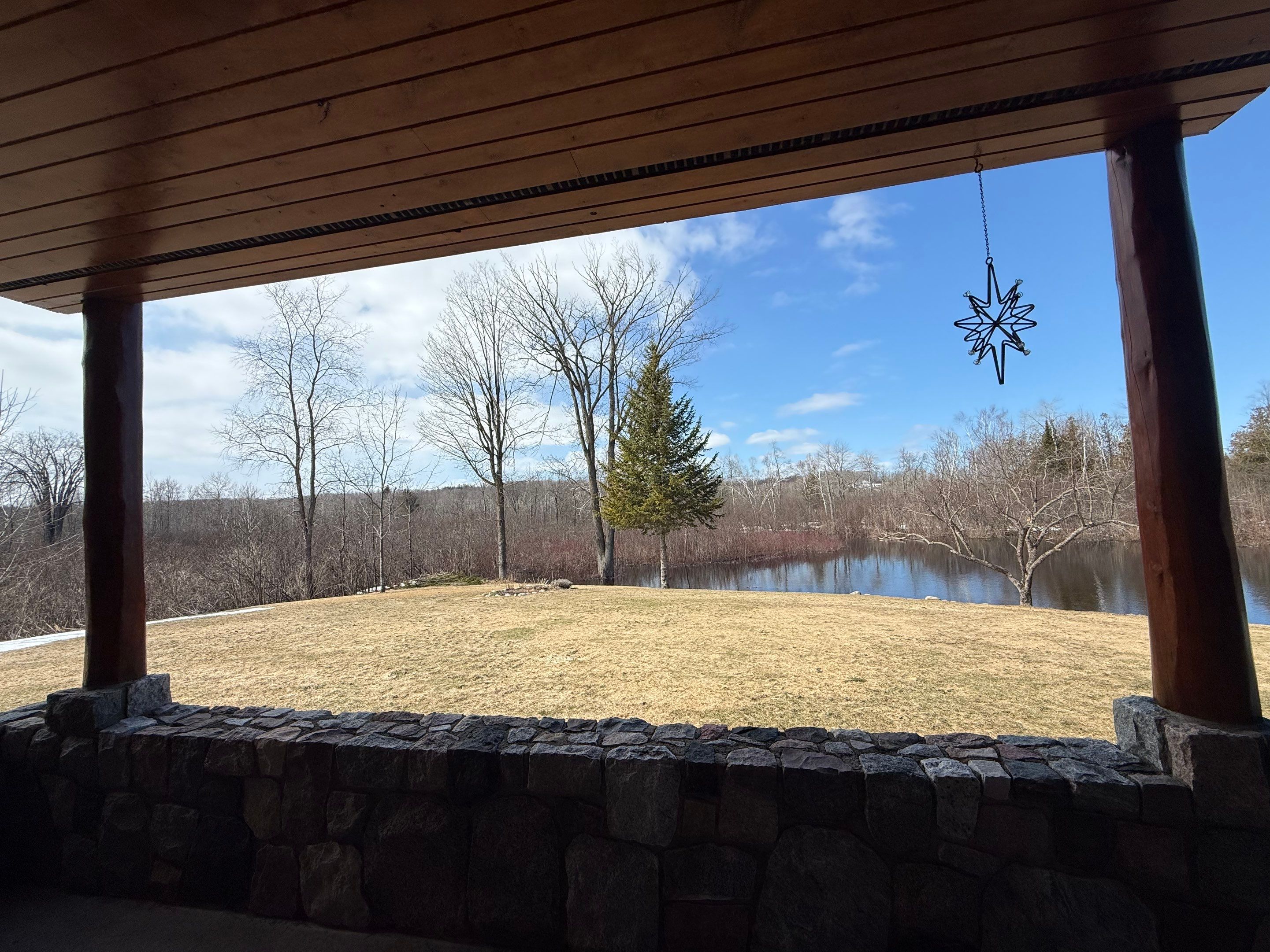 Sunesta Retractable Screen Installation on a Petoskey Log Home Porch by Rainbow Seamless Systems