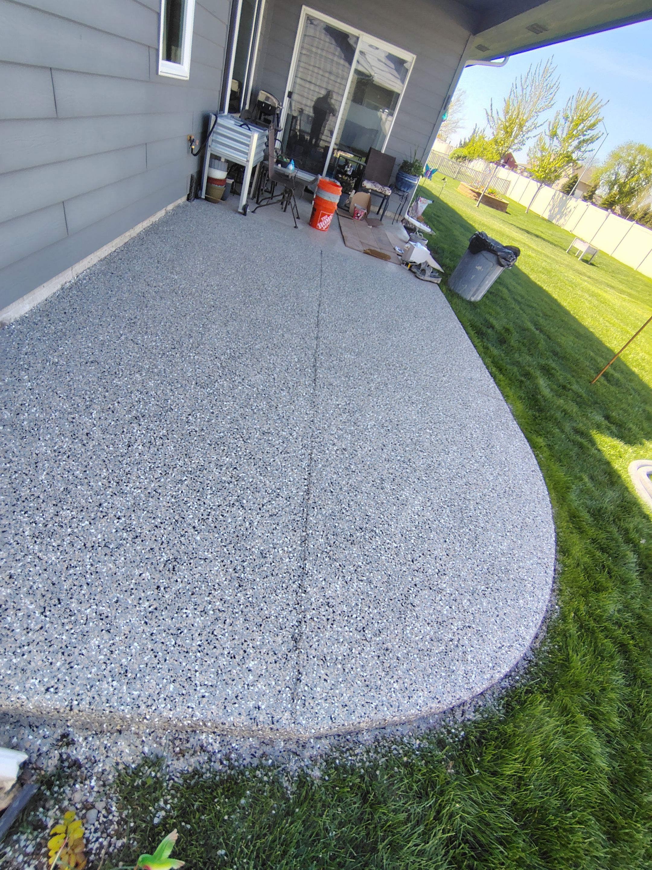 Speckled Concrete Patio Coating Installation in Sioux Falls by Select Painting, Coatings & Garage Cabinets