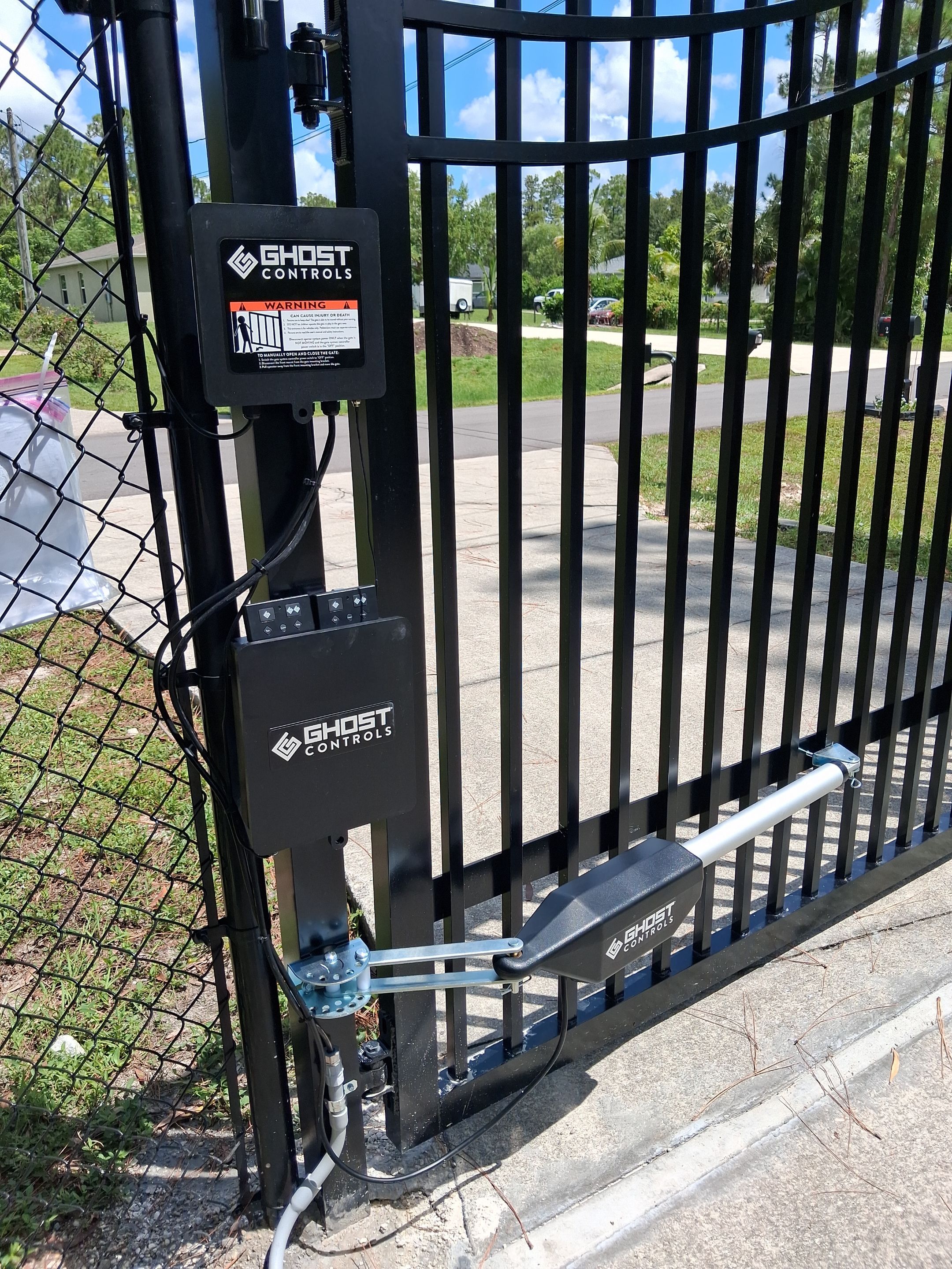 Automated Driveway Gate and Black Chain Link Fence Installation by True Fence LLC