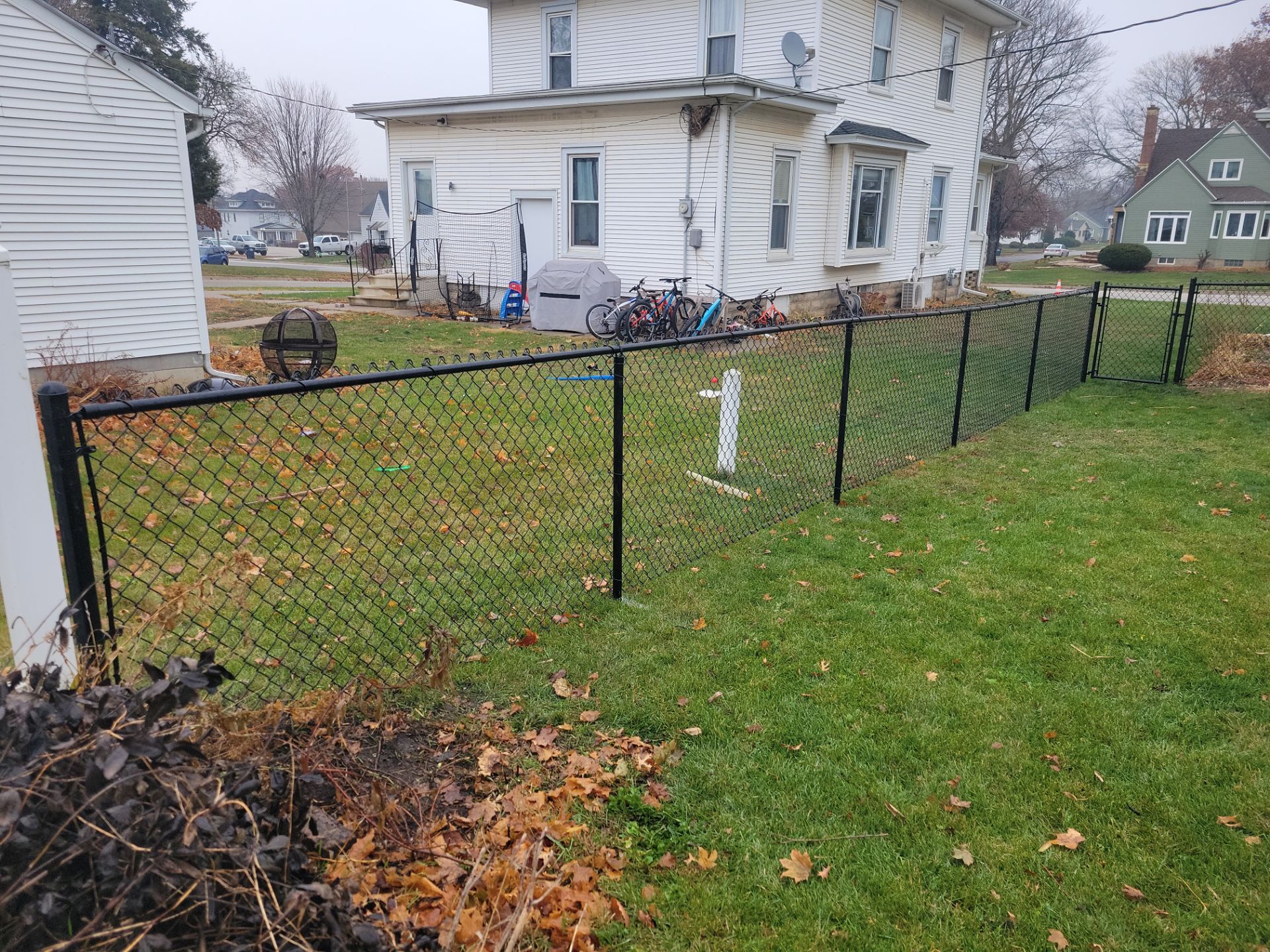 Black Vinyl-Coated Chain Link Fence Installation in Aplington by Perfect Picket Fence and Stain