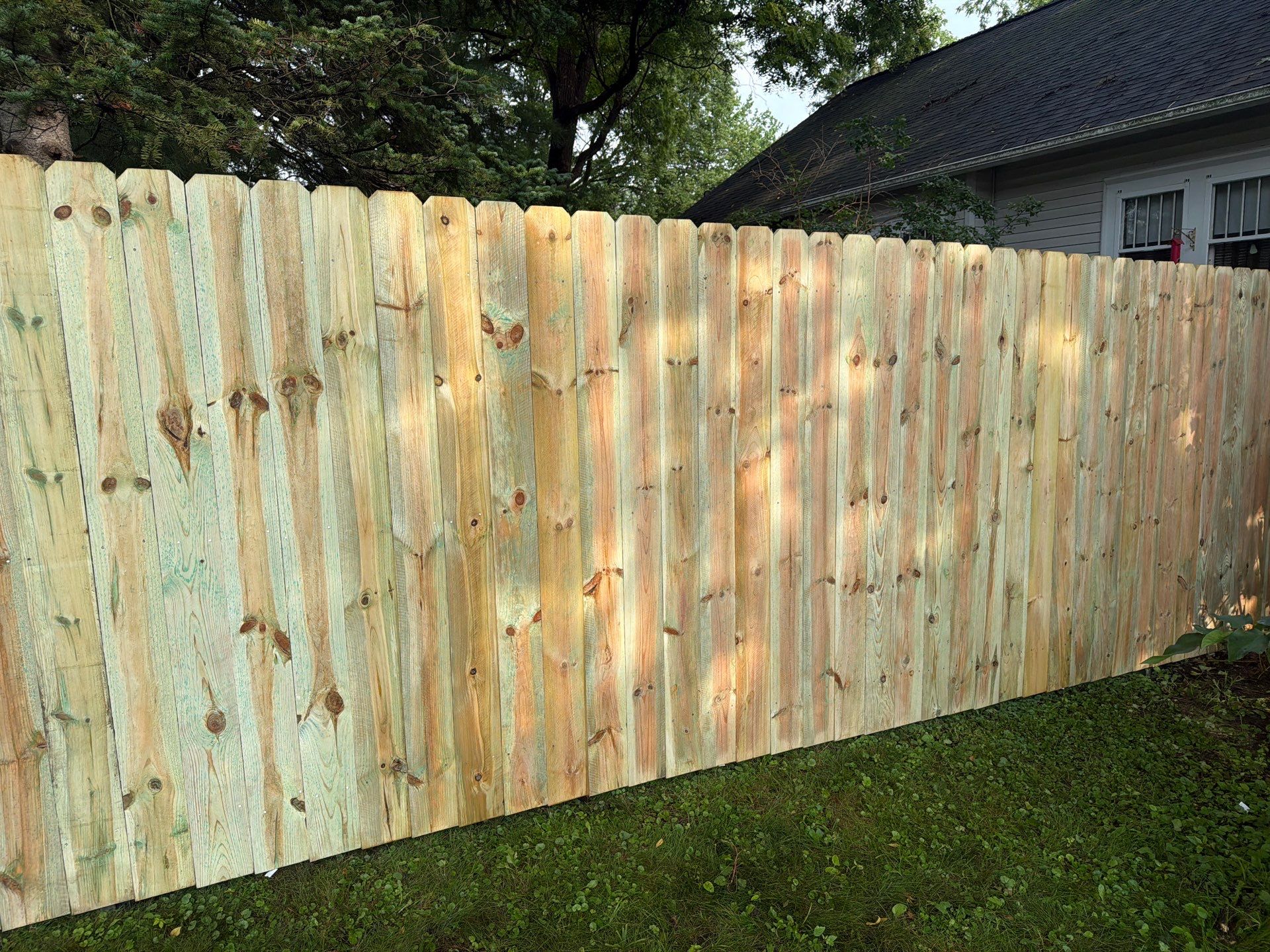Pressure-Treated Pine Privacy Fence Installation in Cedar Falls by Perfect Picket Fence and Stain