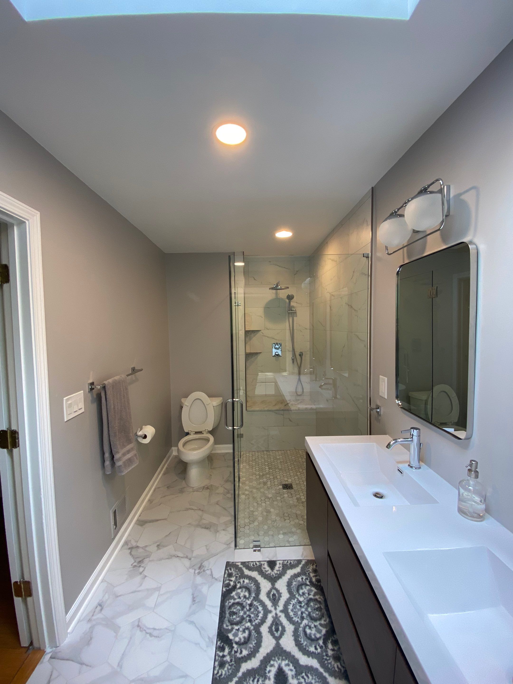 Luxury Bathroom Remodel with Marble Tiles in Kennesaw by Swift Home Renovations 