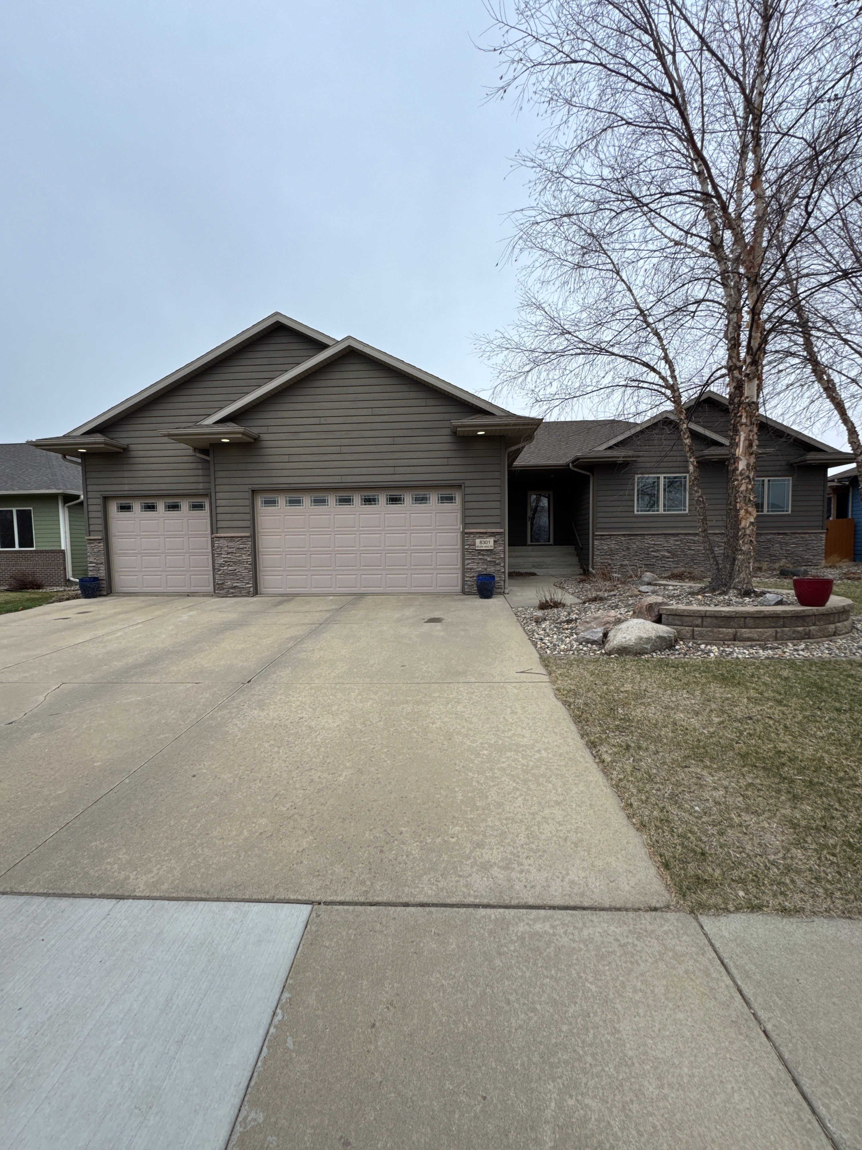 Sioux Falls Residential Exterior Update and Flagstone Pool Deck by Select Painting, Coatings & Garage Cabinets
