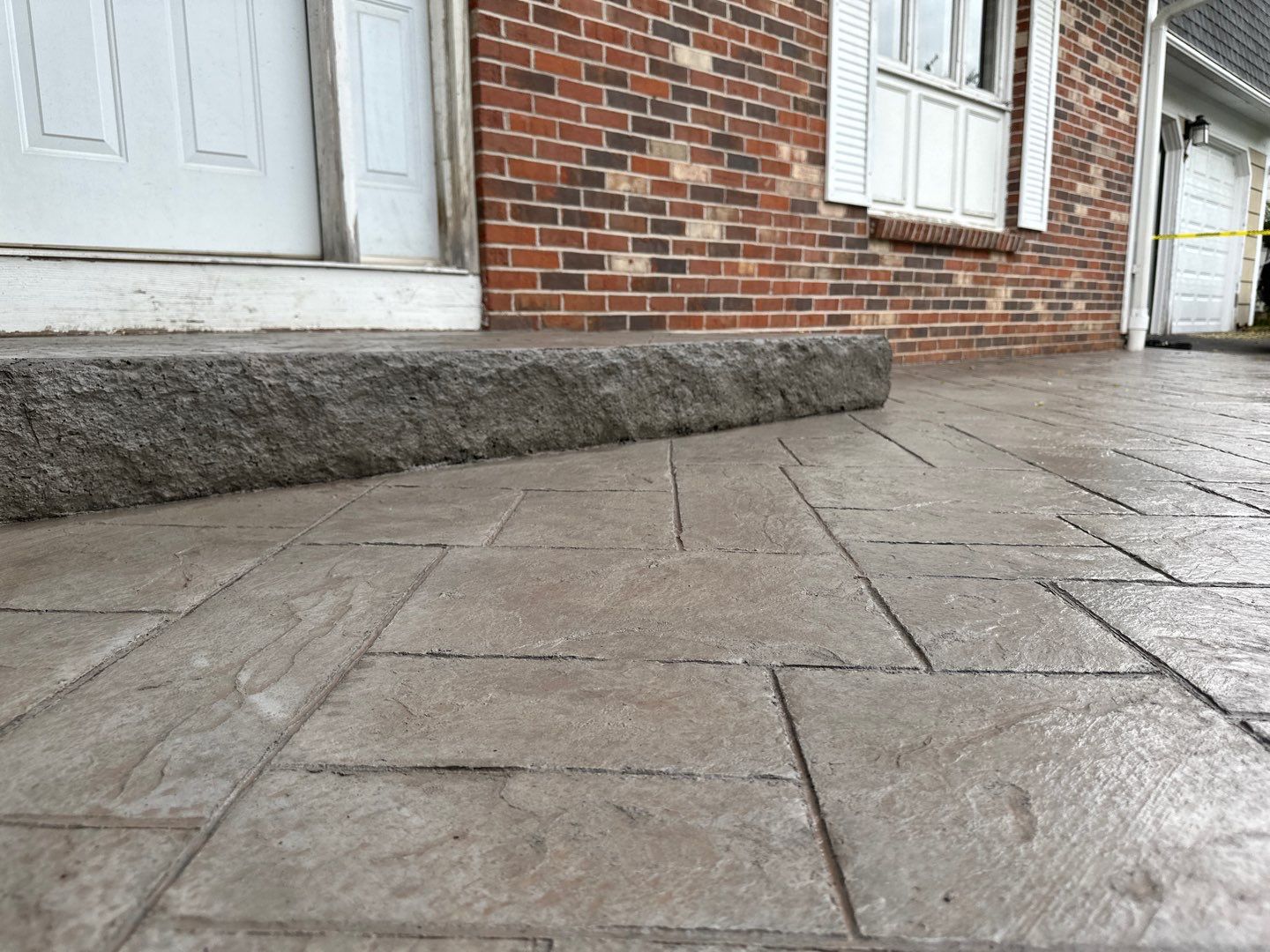 Ashlar slate stamped concrete patio  by NG Masonry & Construction LLC