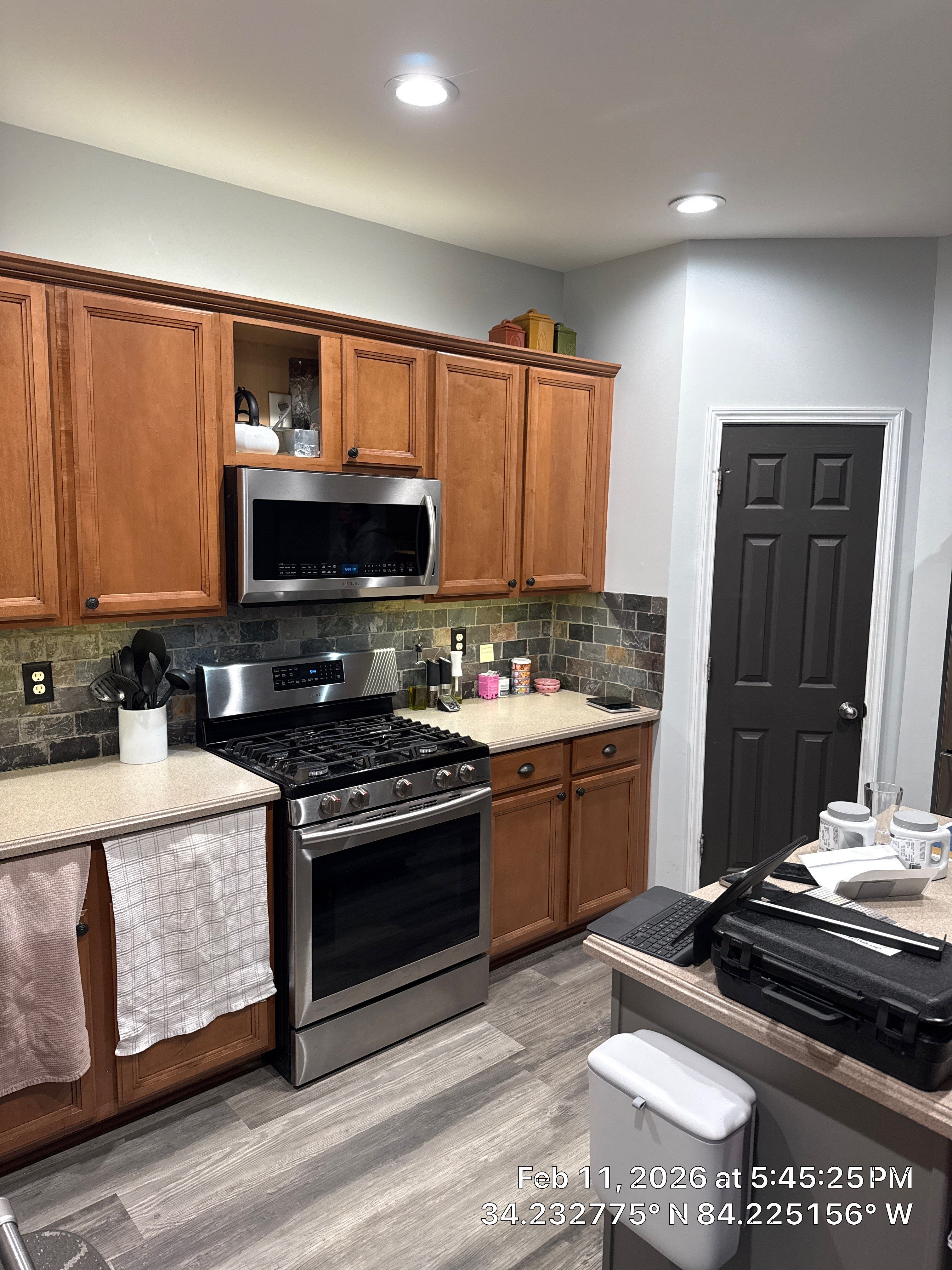 Modern Kitchen Remodel With Grey Shaker Cabinets and Navy Blue Island by Heart & Home Kitchen & Bath Remodeling LLC