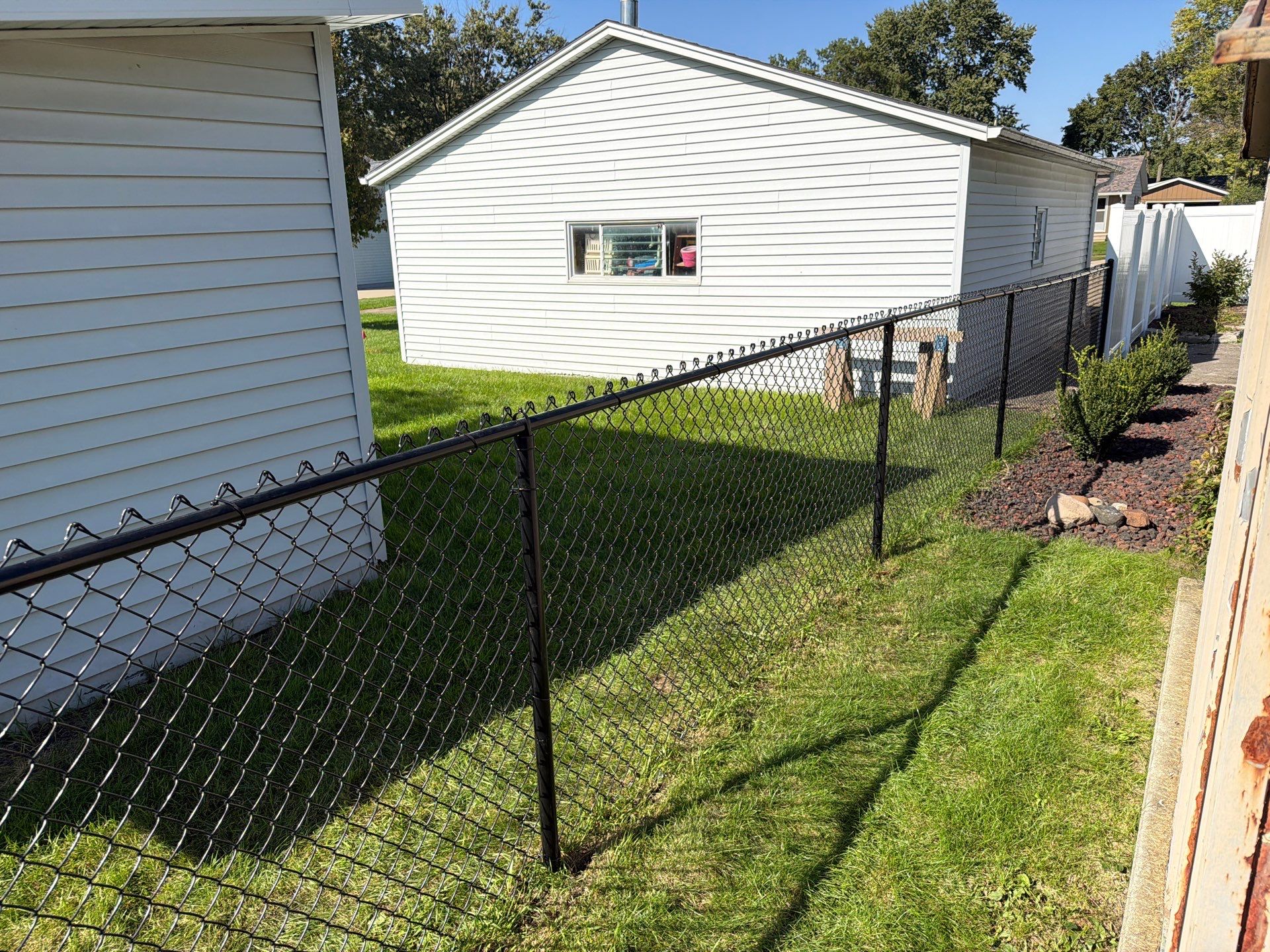 Custom Vinyl Privacy and Black Chain Link Fence Installation in Cedar Falls by Perfect Picket Fence and Stain