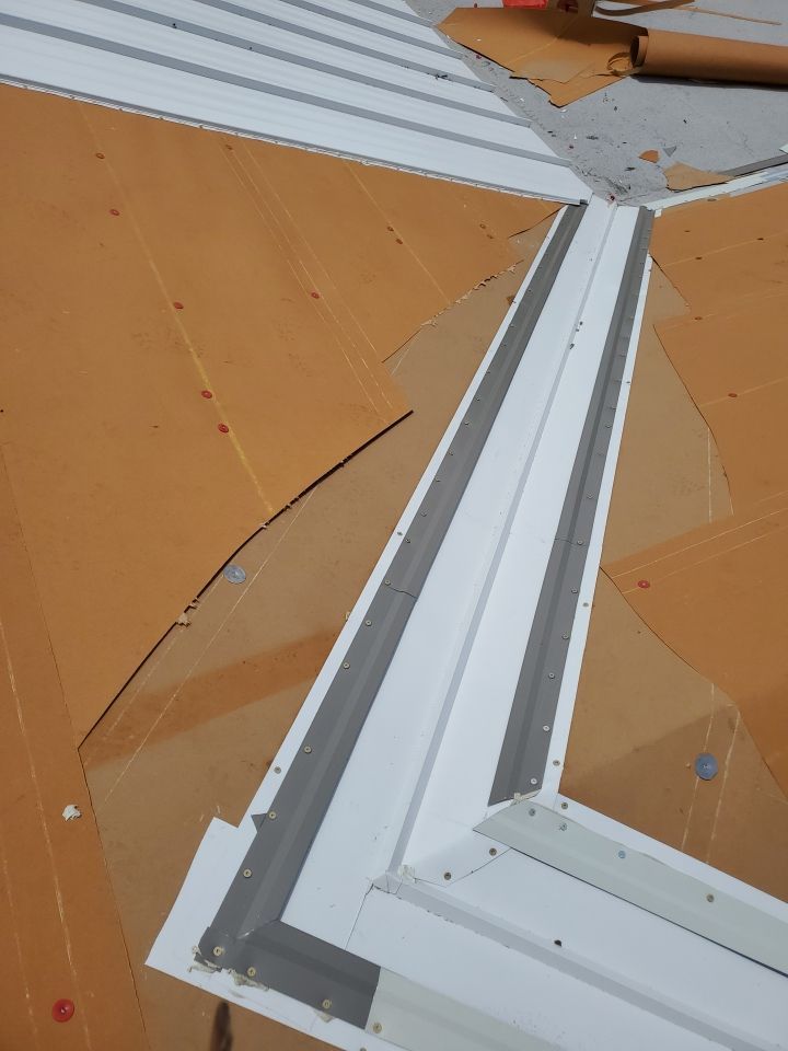 Residential Roofing Installation using 1.5" Nail Strip 24ga Solar White Kynar Coated Standing Seam Metal Panels by Morton Roofing, Inc.