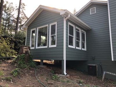 Elevated Sunroom Addition Featuring Dark Gray Siding in Kennesaw