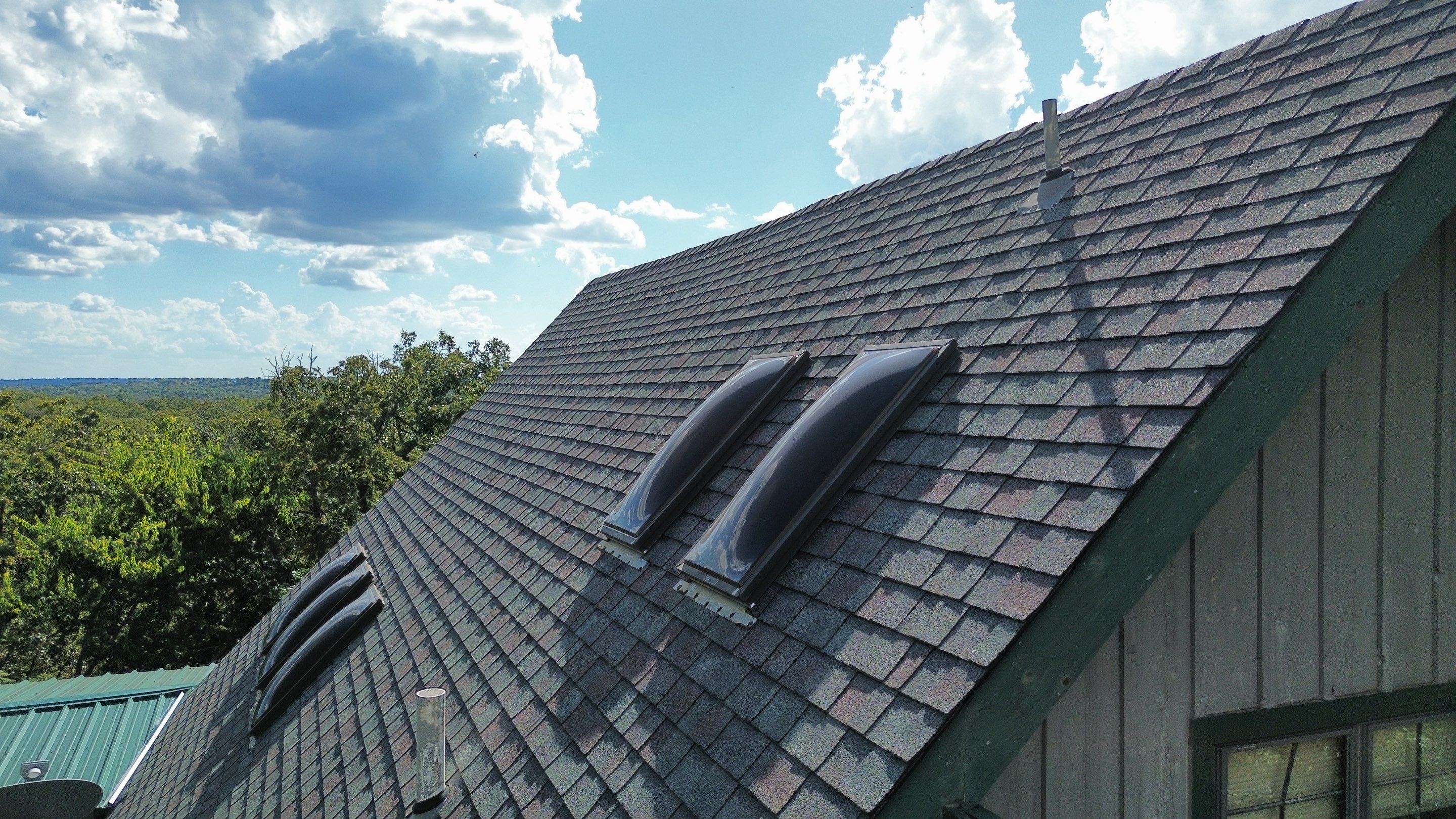 Architectural Shingle Roof Replacement and Skylight Installation in Sulphur by BANA Roofing and Solar Supply