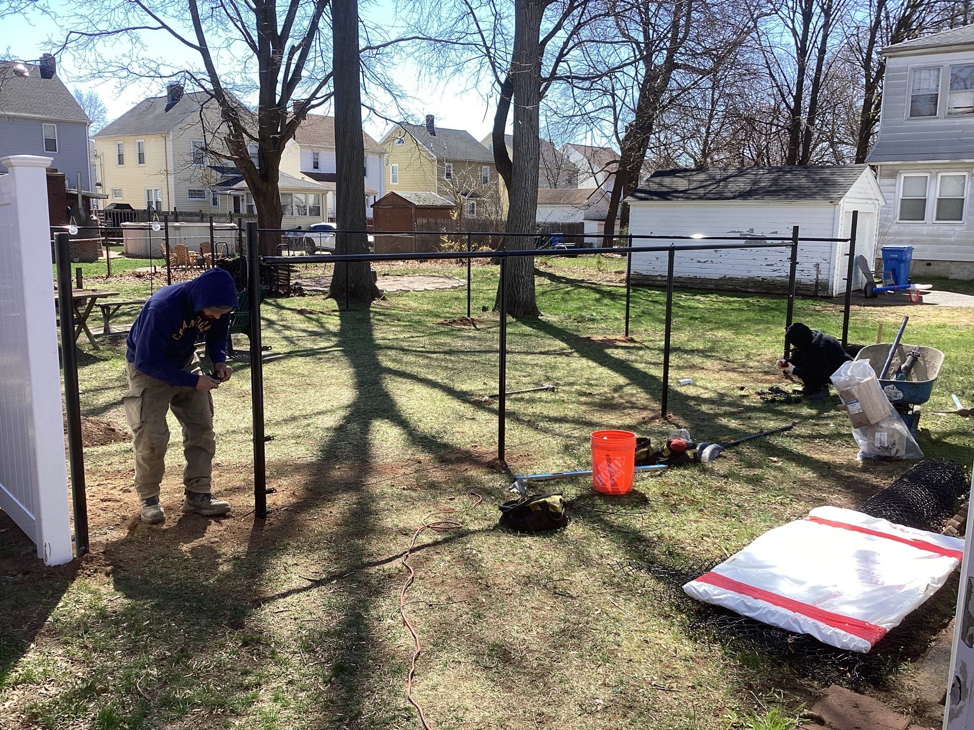 New Black Chain link and White Vinyl privacy fence with matching chain link gate. by DiGiorgi Roofing and Siding Inc