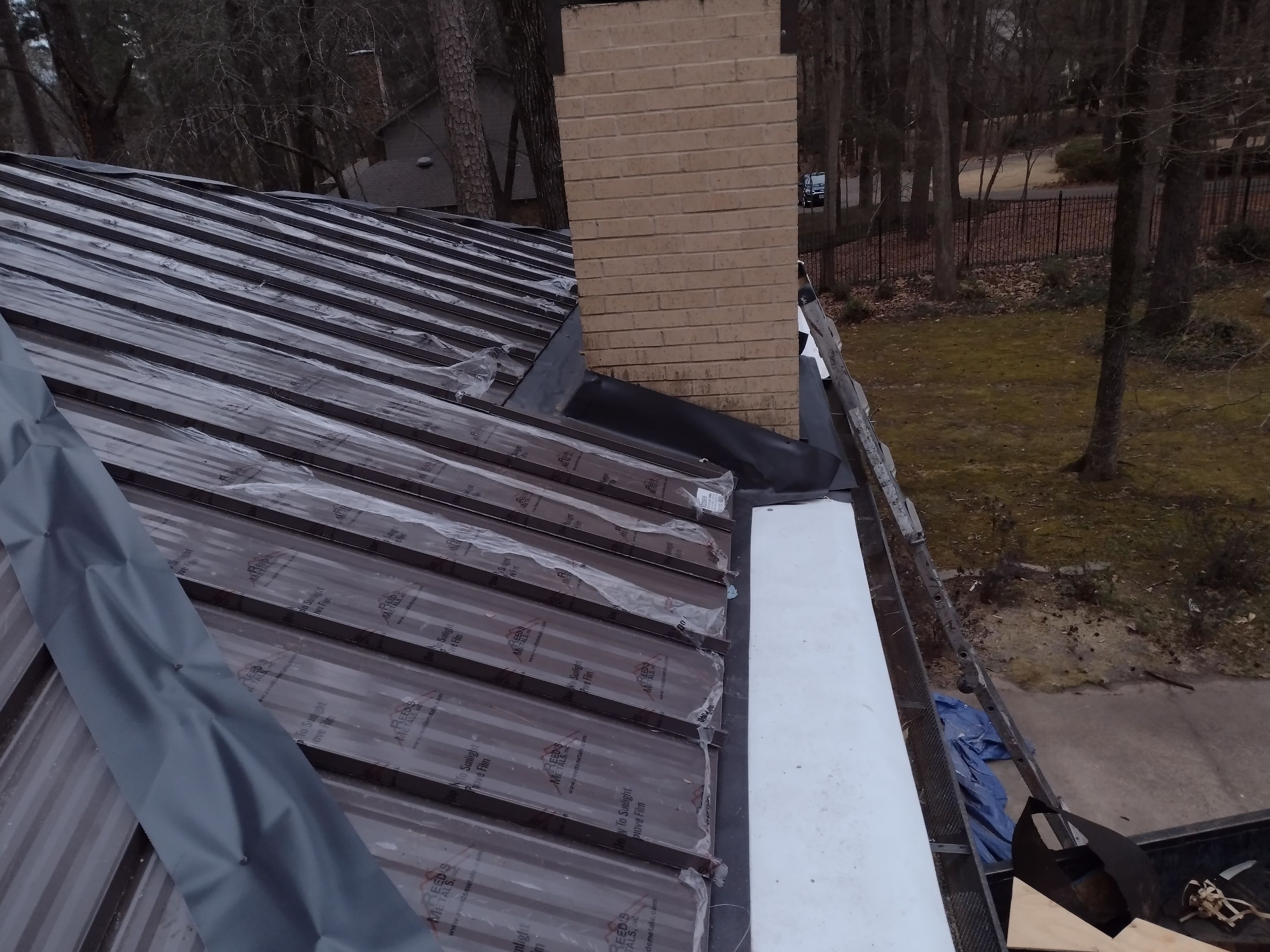 Residential Roofing Installation using PVC membrane and 24 gauge Standing Seam Metal by Hostetler Roofing