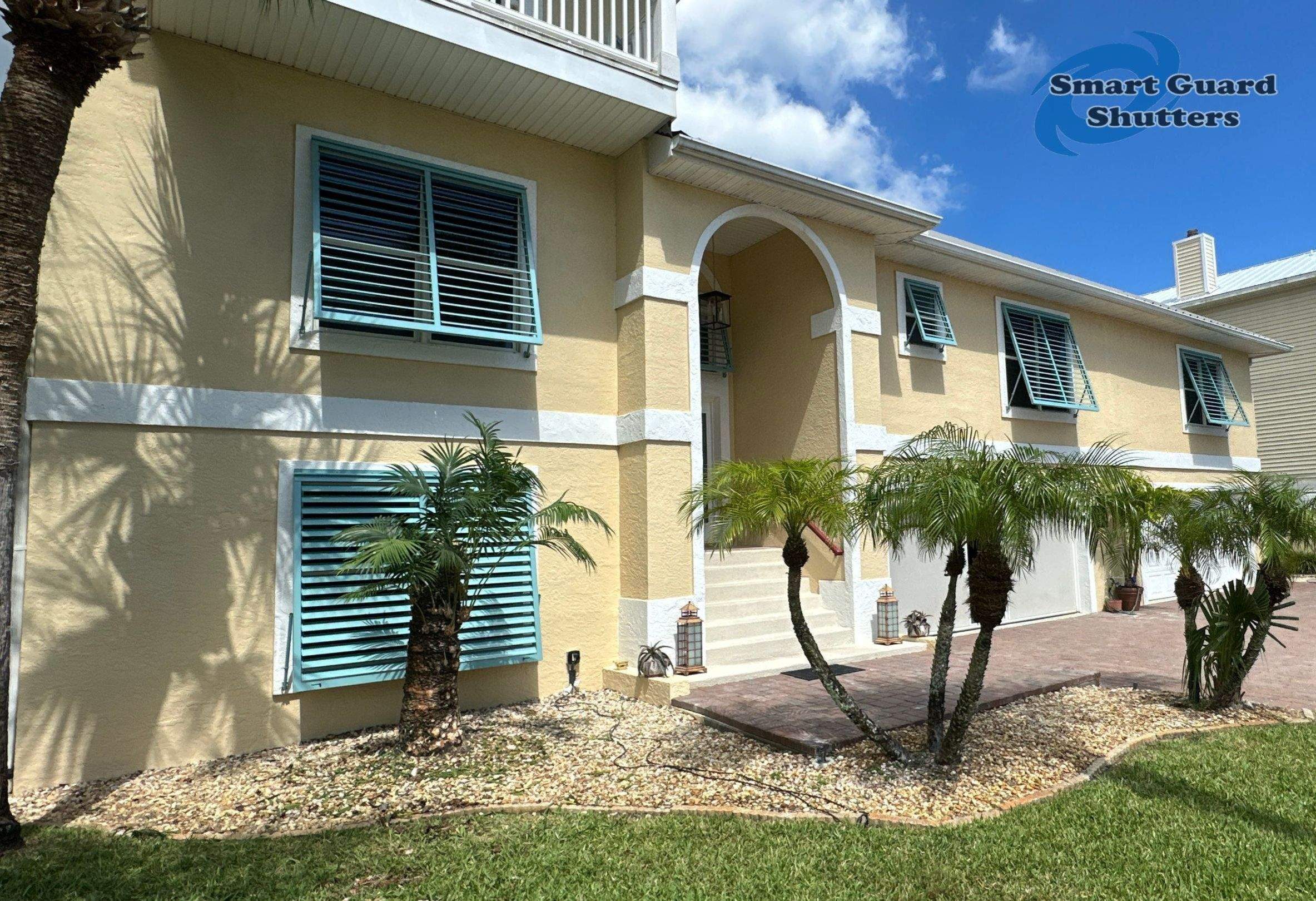 Impact Bahama Shutters in Pastel Turquoise by Smart Guard Shutters