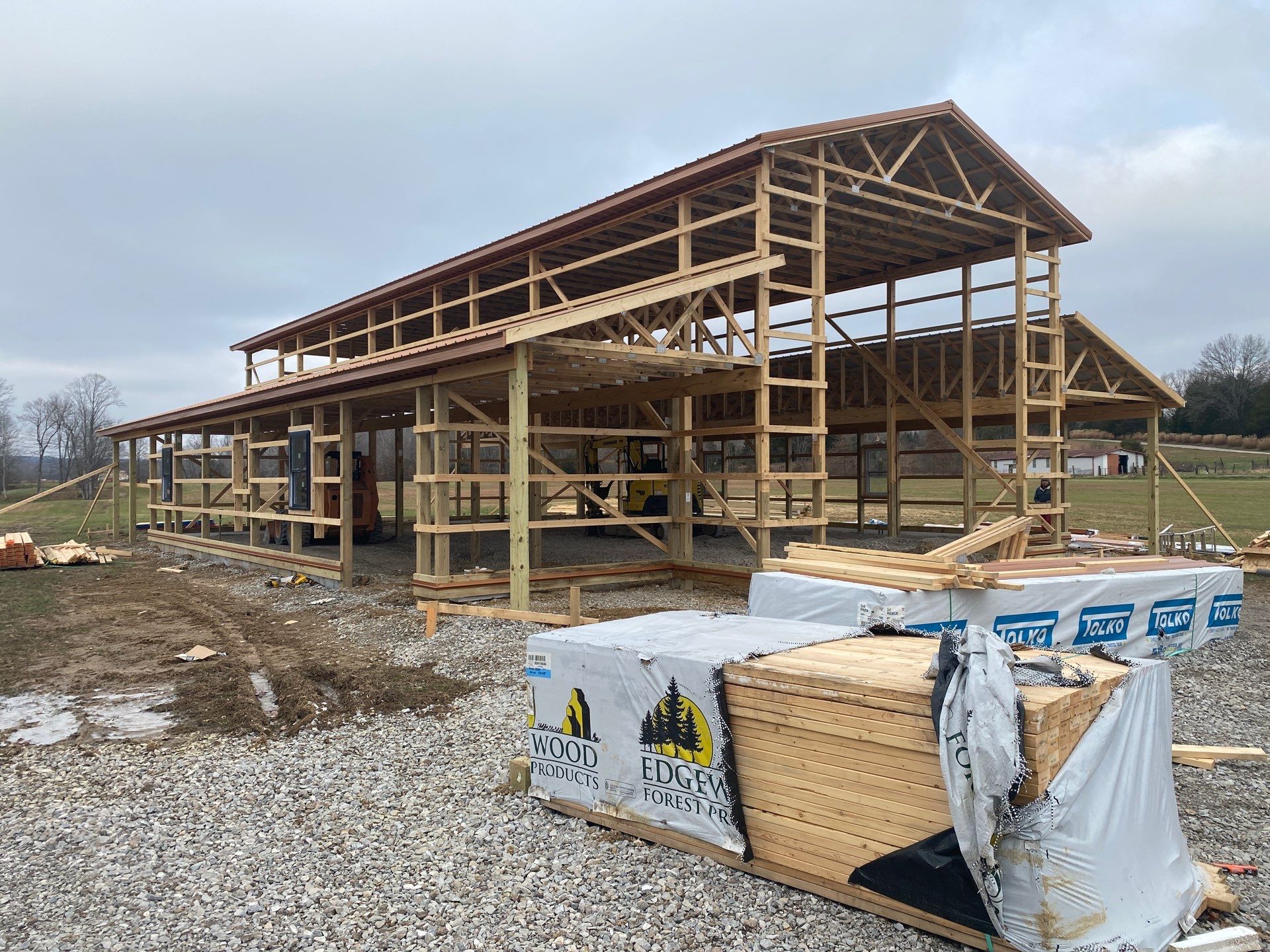 Custom Pole Barn Home with Charcoal Siding and Copper Roof by The Barn Builders