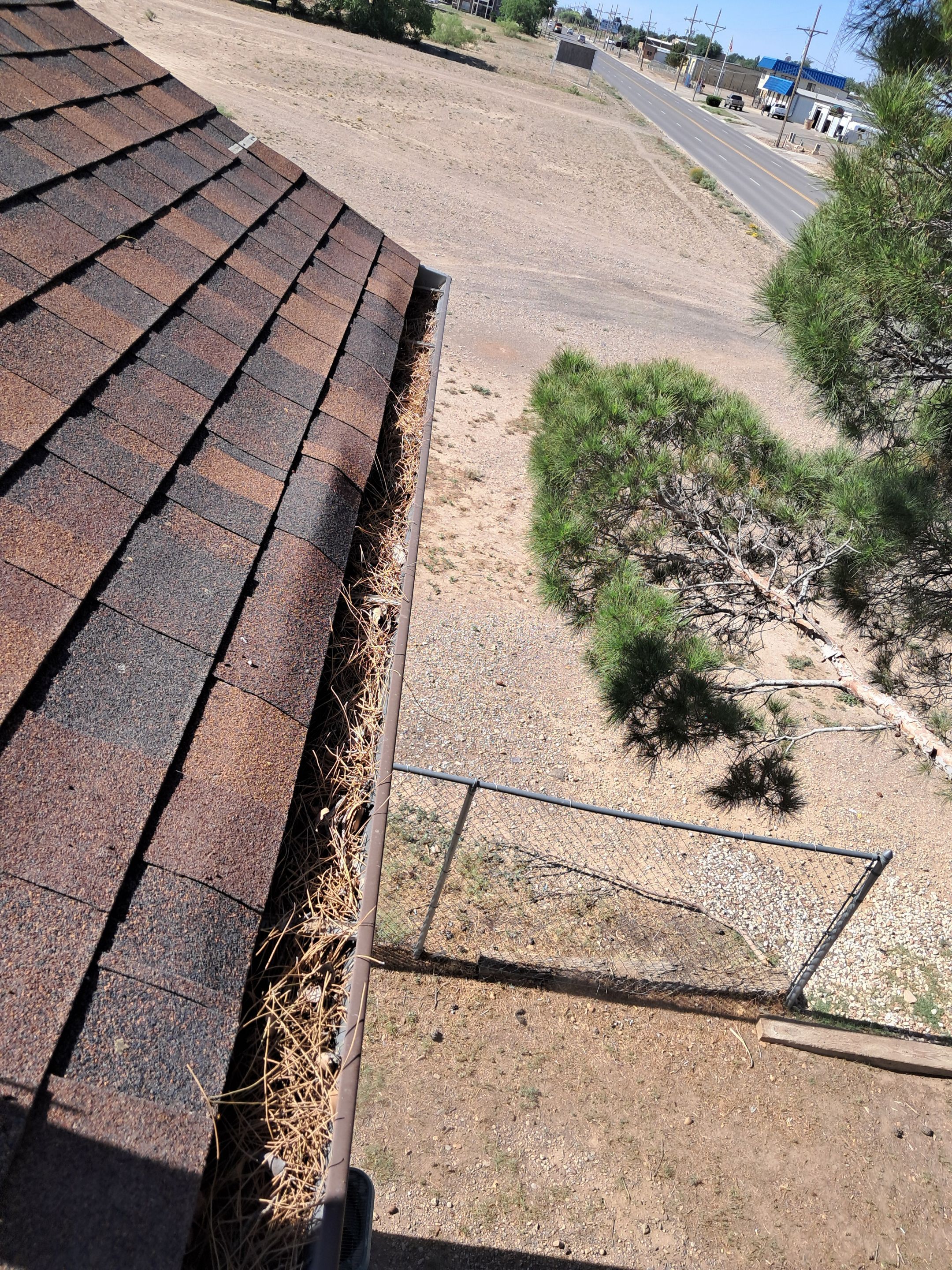 Commercial gutter cleaning New Mexico before photo with filled gutters