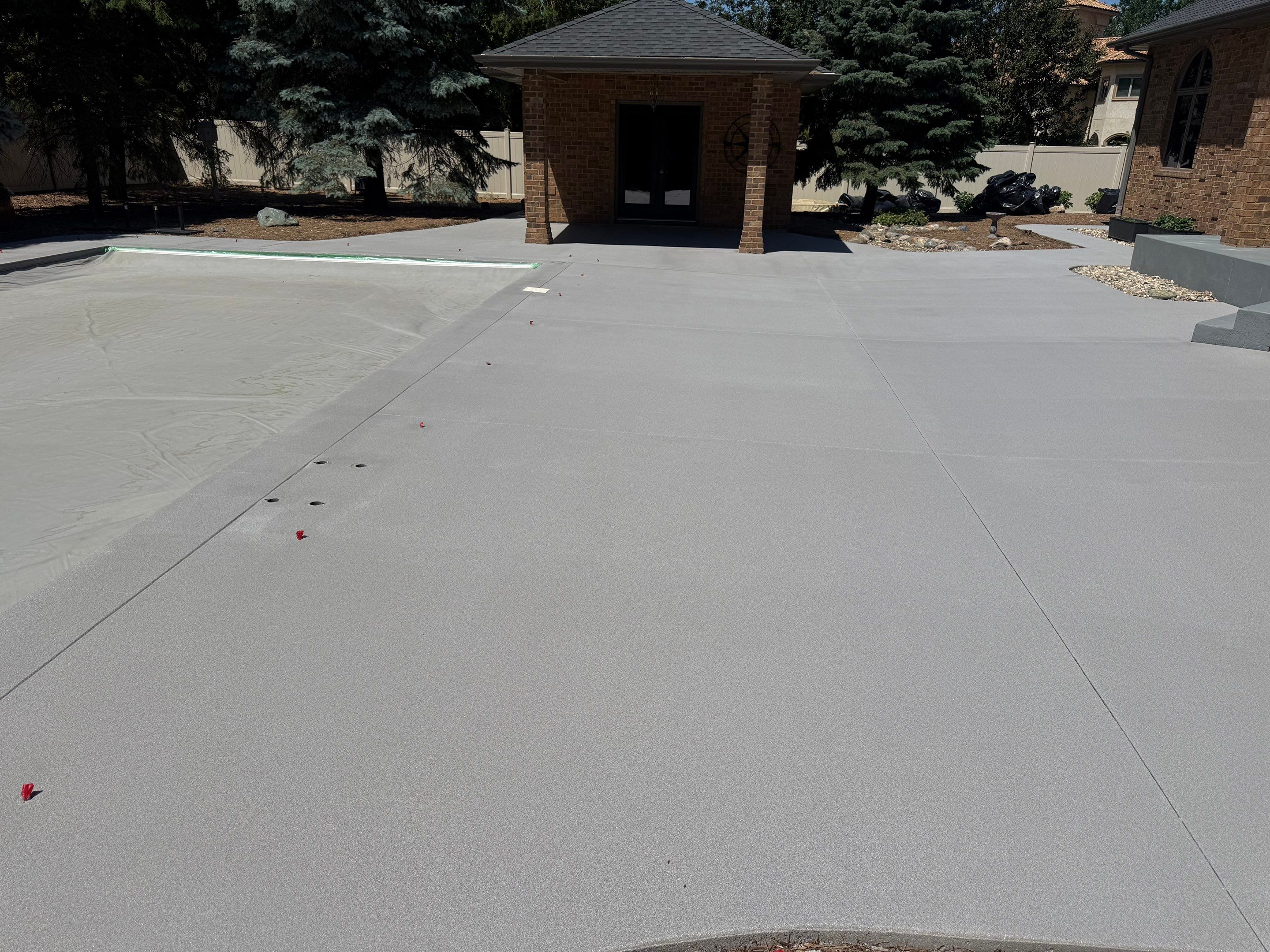 Decorative Concrete Pool Deck and Patio Resurfacing in Sioux Falls by Select Painting, Coatings & Garage Cabinets