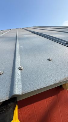Low angle view of a metal roof edge.