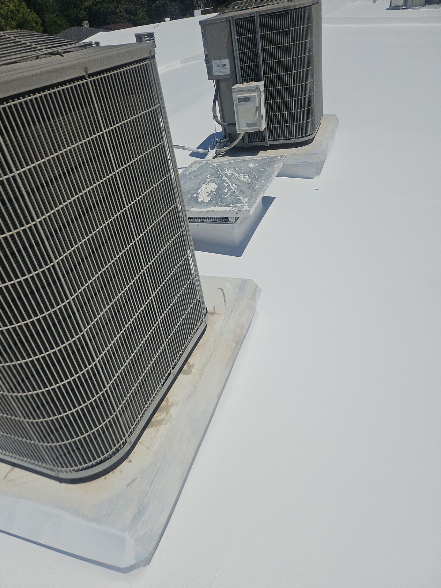 Single-ply restoration system using Benchmark/PUMA XL coatings over TPO single-ply roofing by Straight Edge Roofing Inc