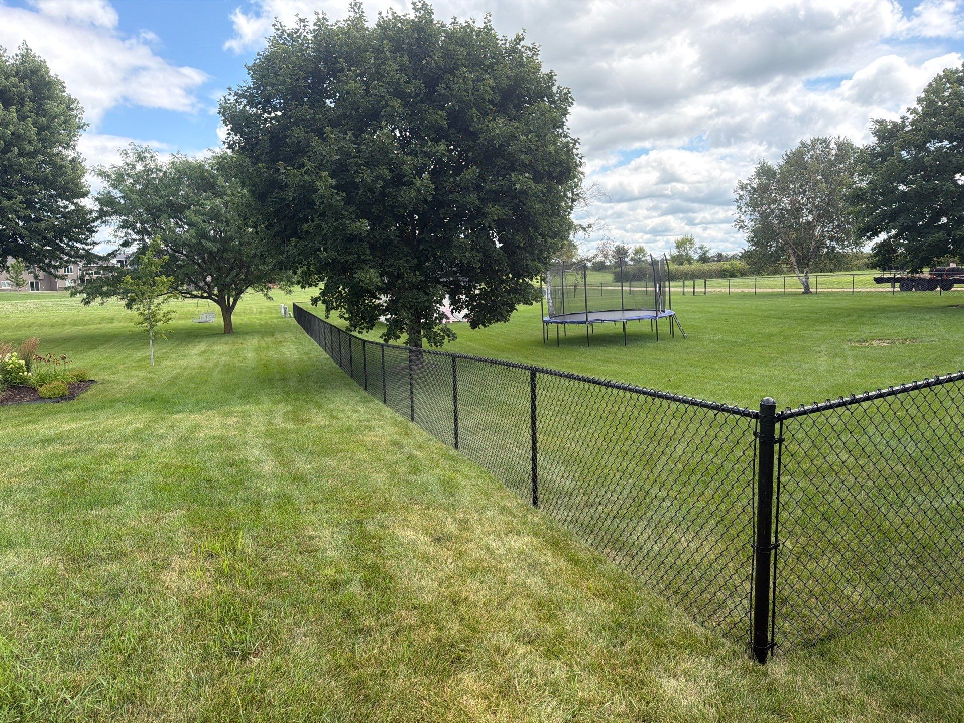 Black Vinyl-Coated Chain Link Fence Installation in Fairbank by Perfect Picket Fence and Stain