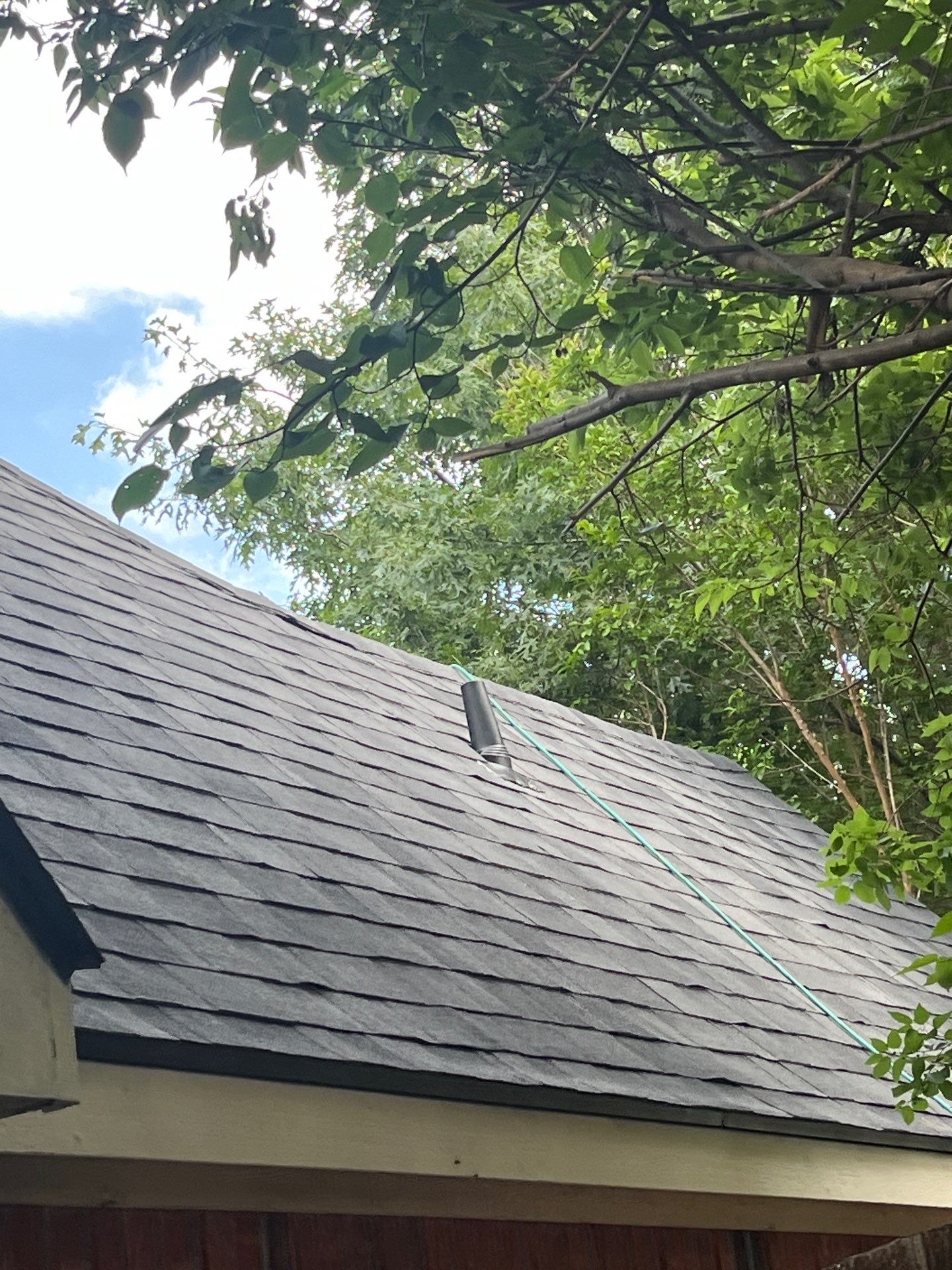 Red brick with Malarkey Midnight Black  by Tejas Roofworks + Restoration