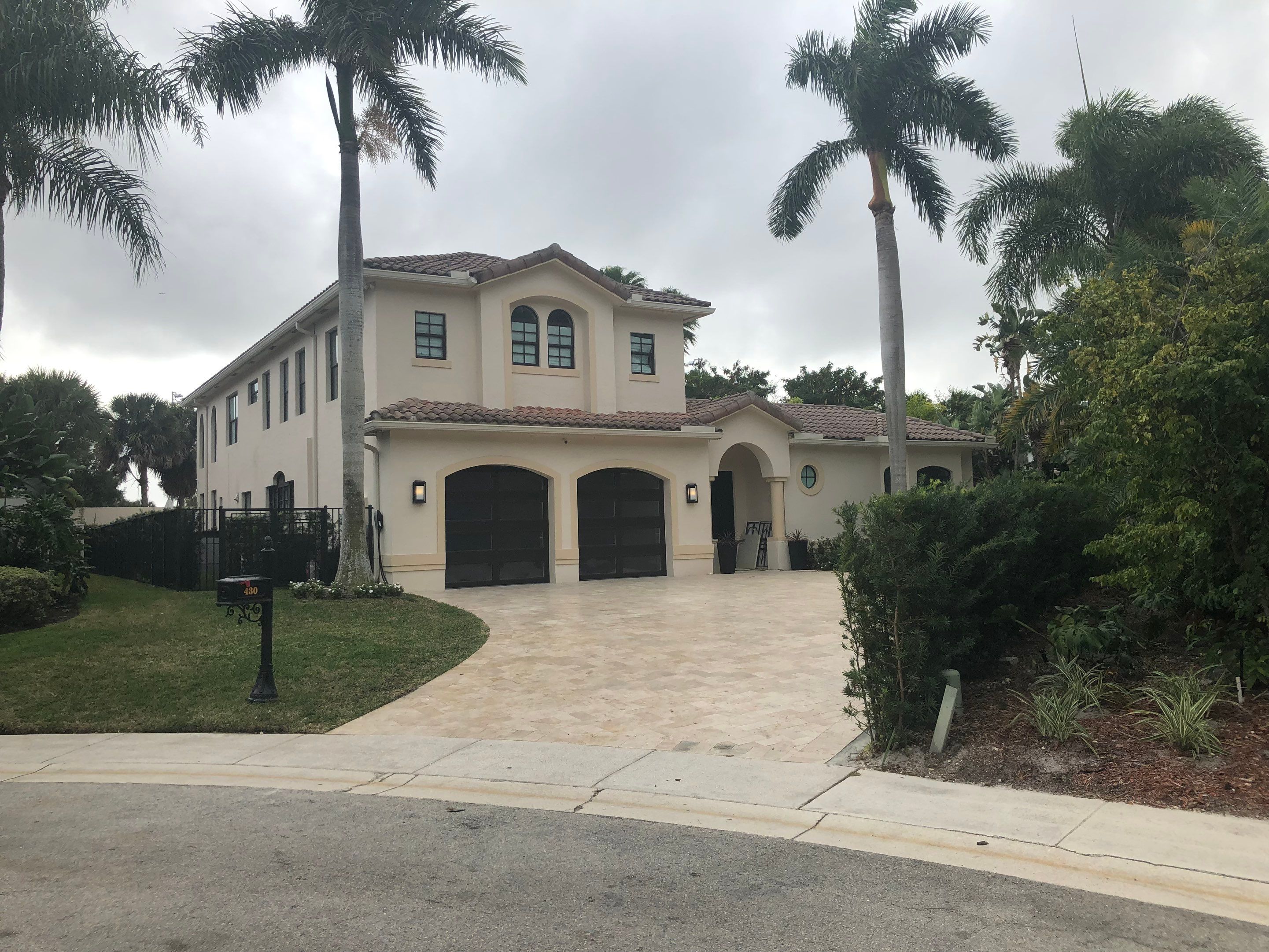Modern Bronze Garage Door Installation With Frosted Glass in Boca Raton by The Door Doctor of South Florida, Inc.