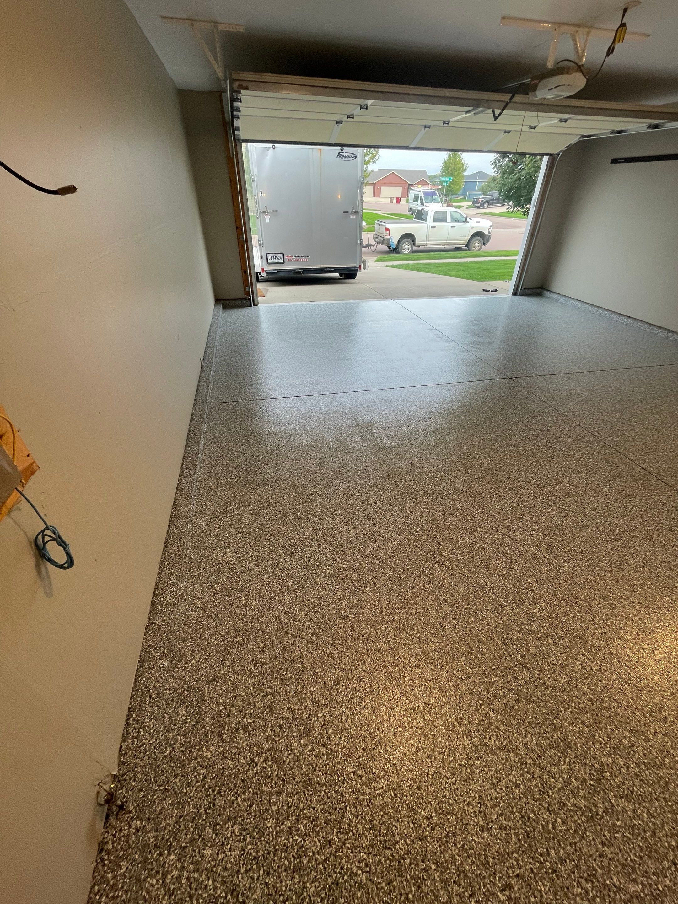 Custom Polyurea Flake Garage Floor Installation in Sioux Falls by Select Painting, Coatings & Garage Cabinets