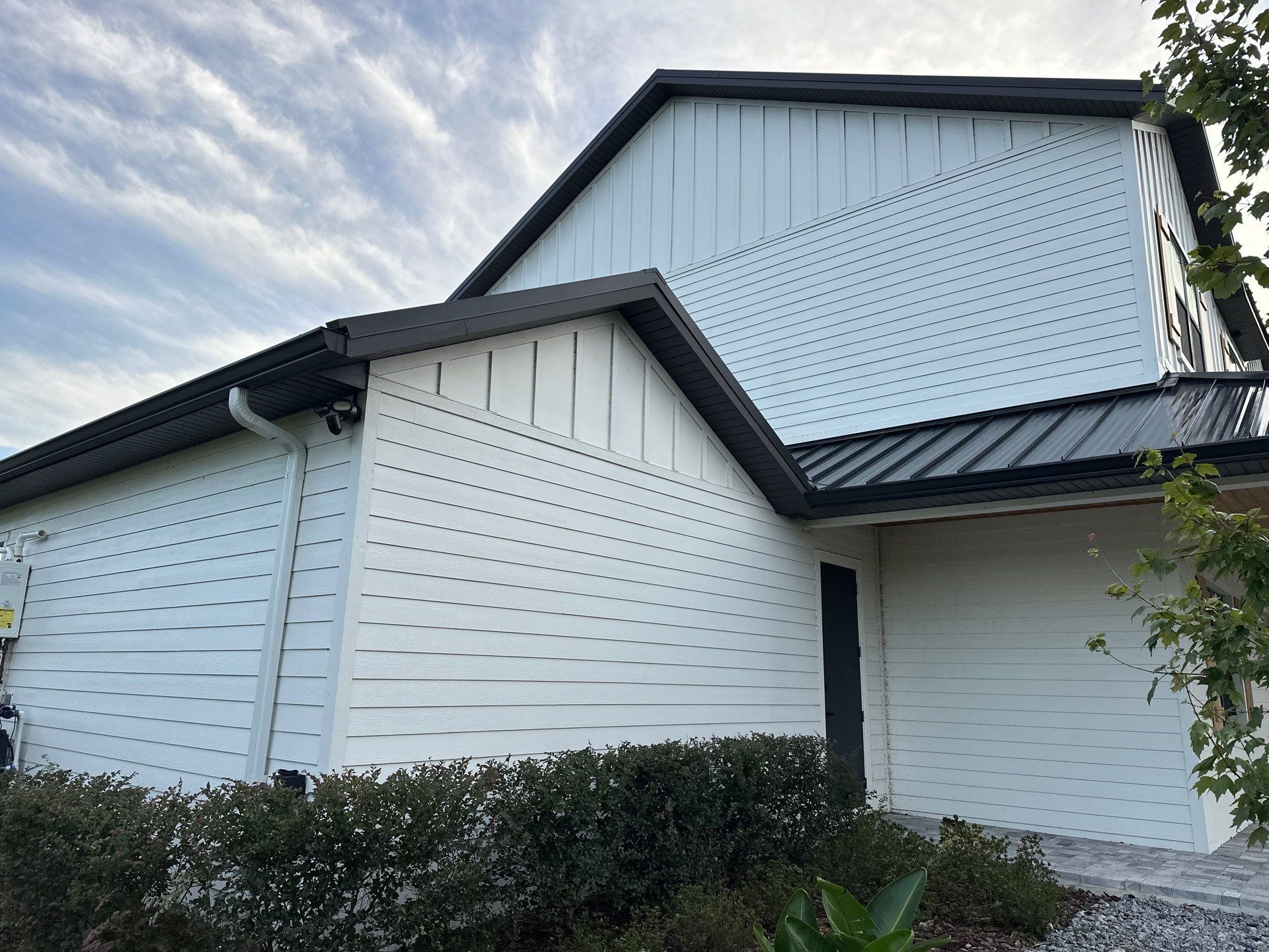 Complete Two-Story House Wash and Driveway Cleaning in Winding River Community, Bradenton, FL by Sunshine AquaWash