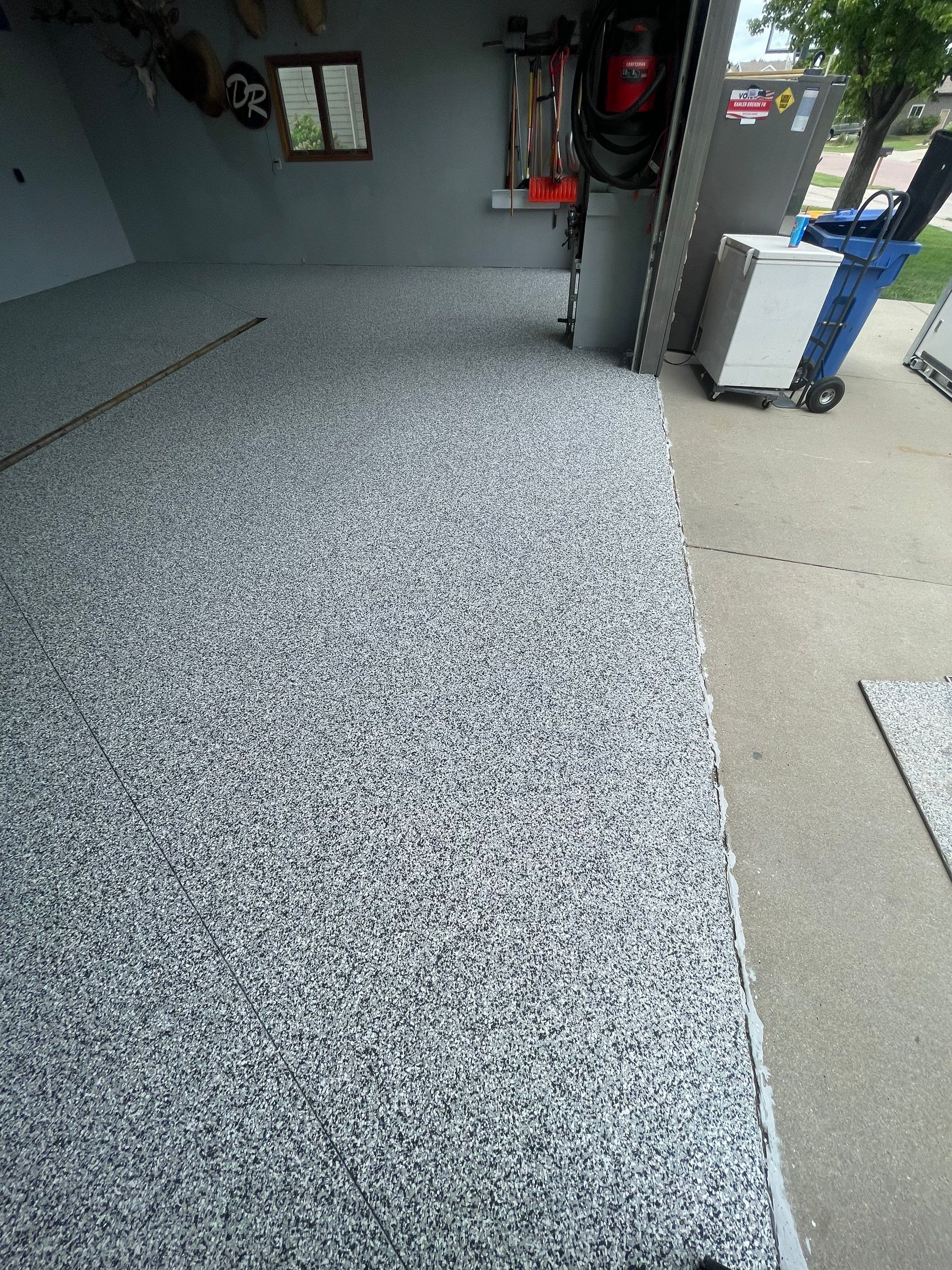Full Garage Floor Epoxy Coating Installation in Dell Rapids by Select Painting, Coatings & Garage Cabinets