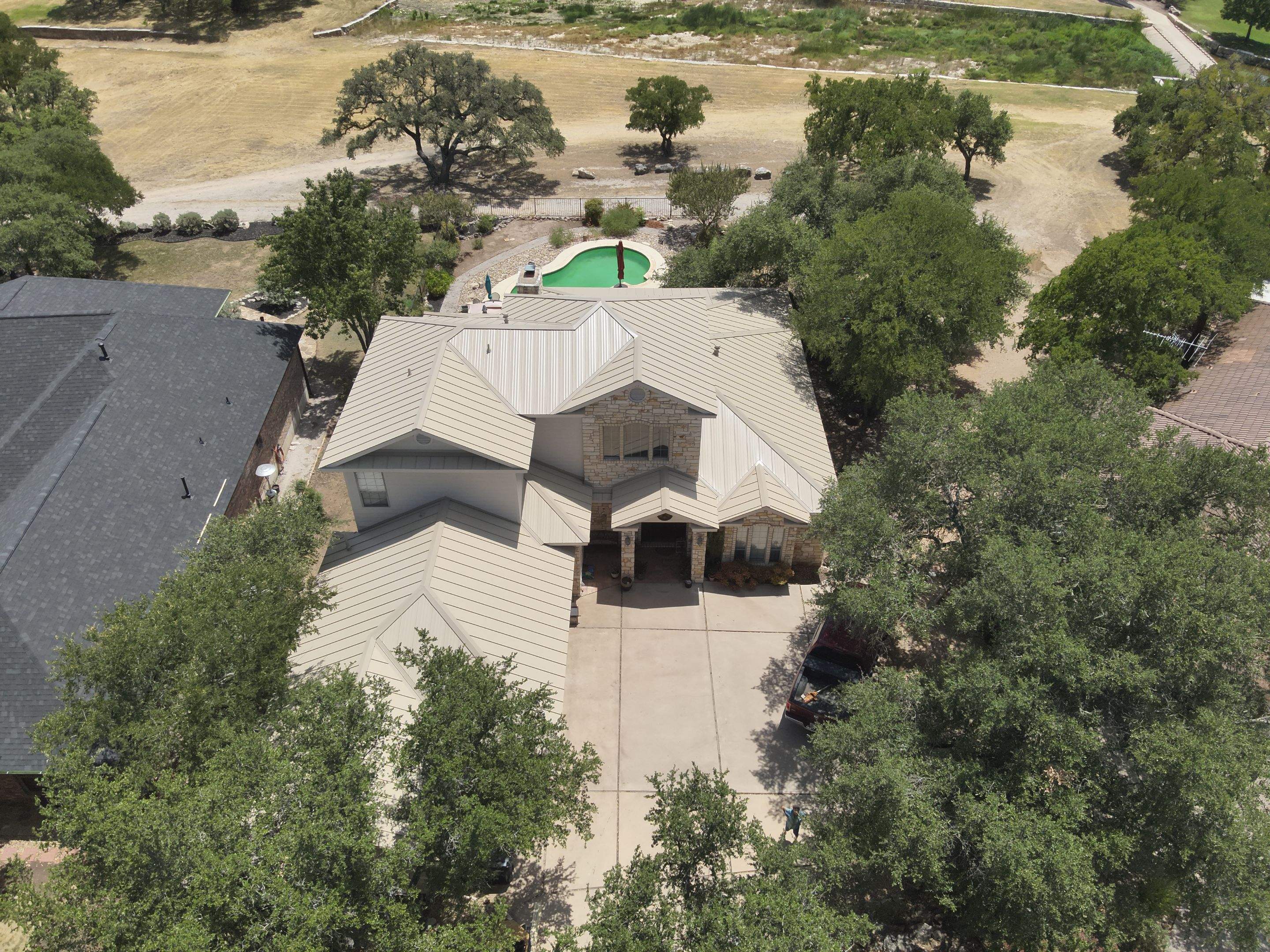 Residential Roof Replacement using 24 GA Double-Lock - Surrey Beige by Action Exteriors Austin