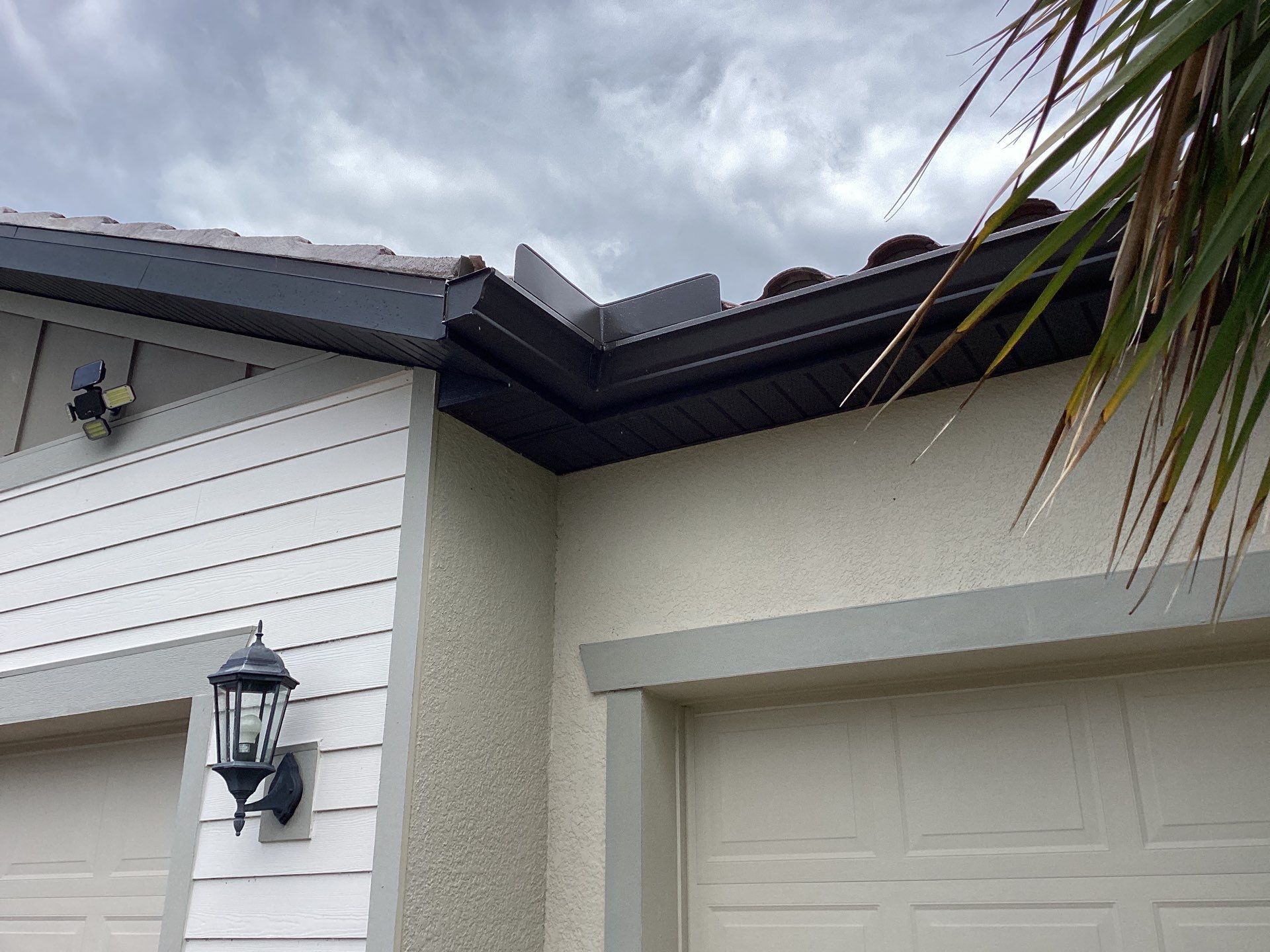 Musket brown seamless gutters with splash guards, new downspouts, and extensions in Bradenton, FL by Gutter Professors