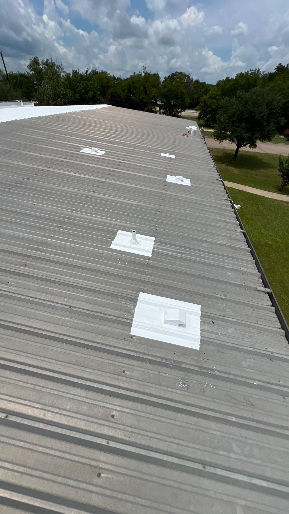 Commercial Roofing Installation using TRP #924 Eterna-Sil Premium Silicone Roof Coating by Harvey Roofing & Construction